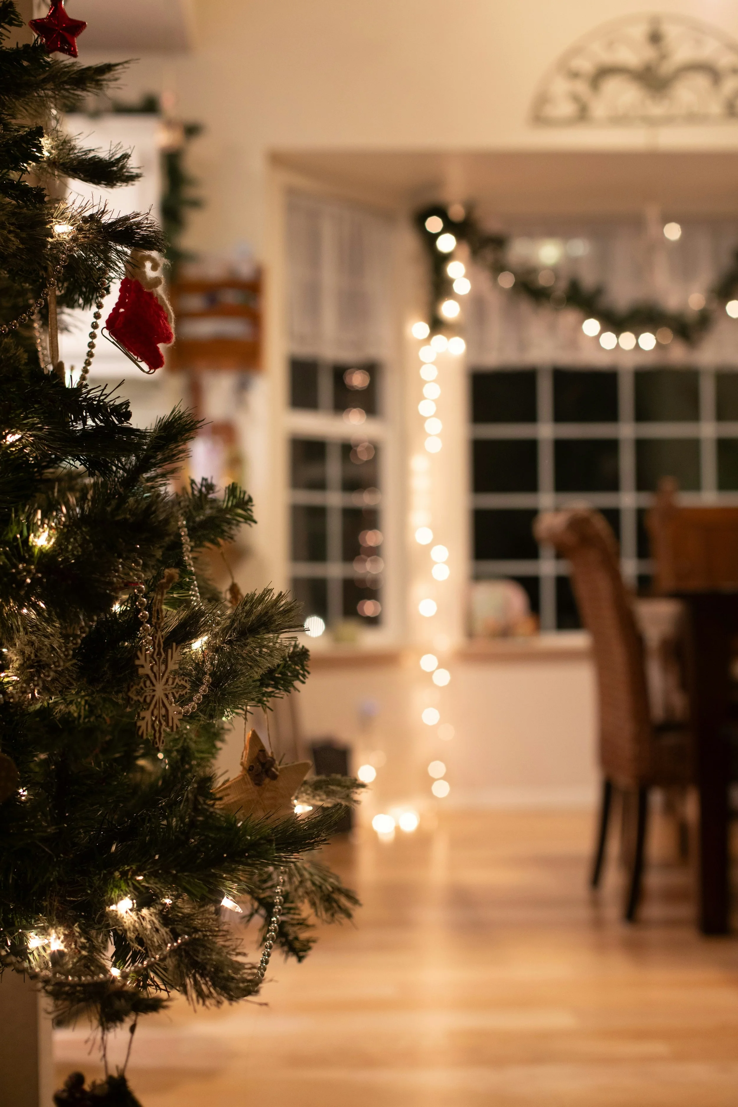 Living room decorated sustainably with reusable Christmas tree, lights, and decor. Reducing holiday consumerism and excess leads to less stressful holiday festivities and better home organization in West Olympia, Washington