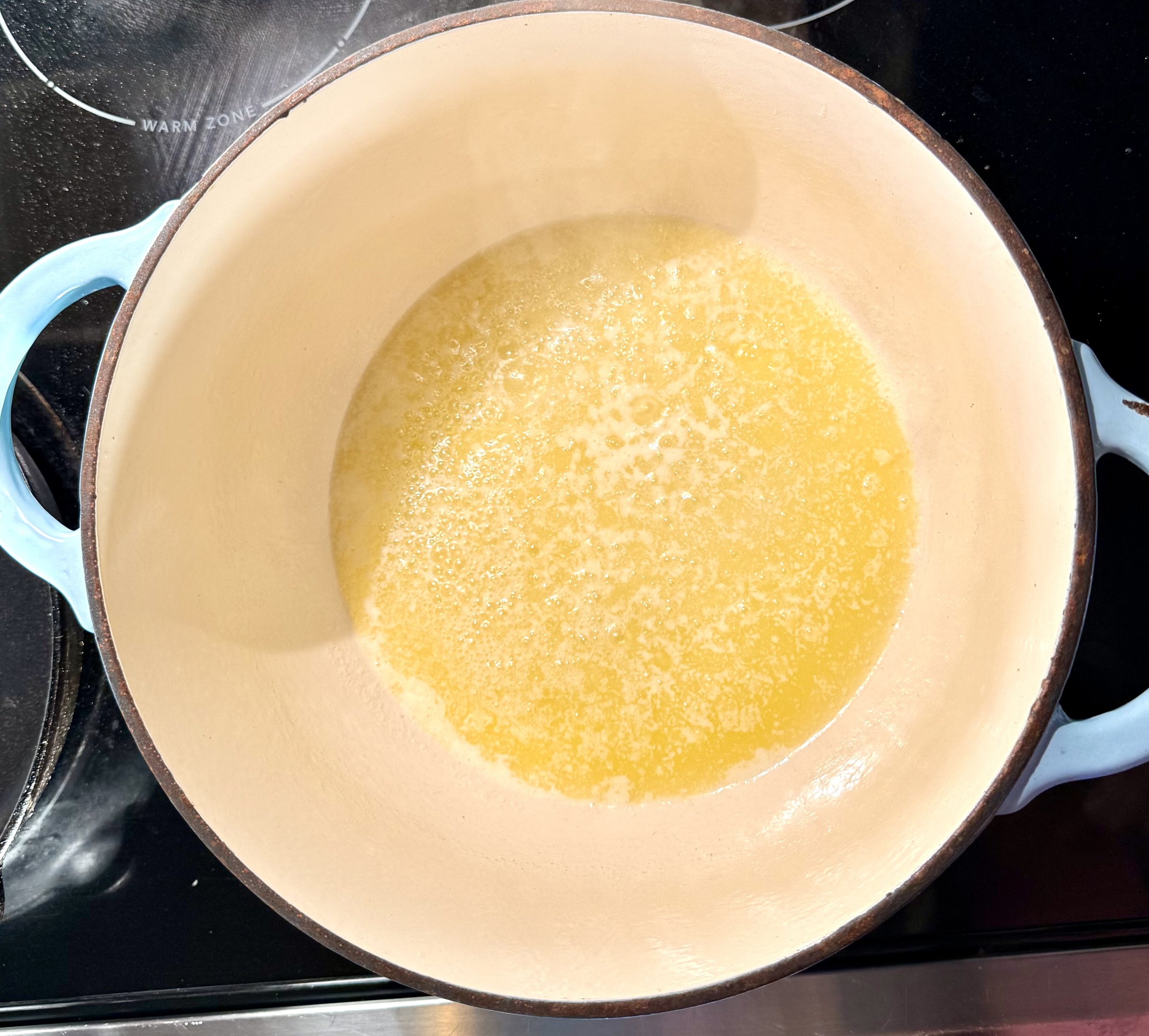 Melted butter in a pan waiting to become rich browned butter for chocolate cobbler base.
