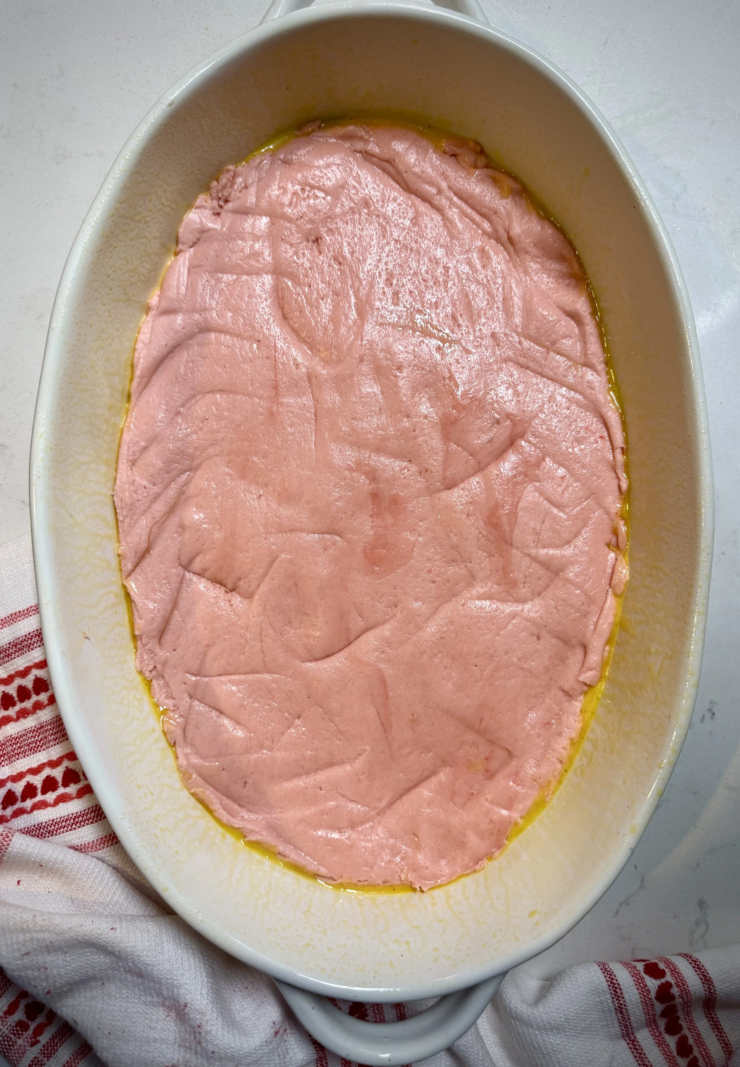 A strawberry cake mix, melted butter, and an egg make up the base of this strawberry gooey butter cake.
