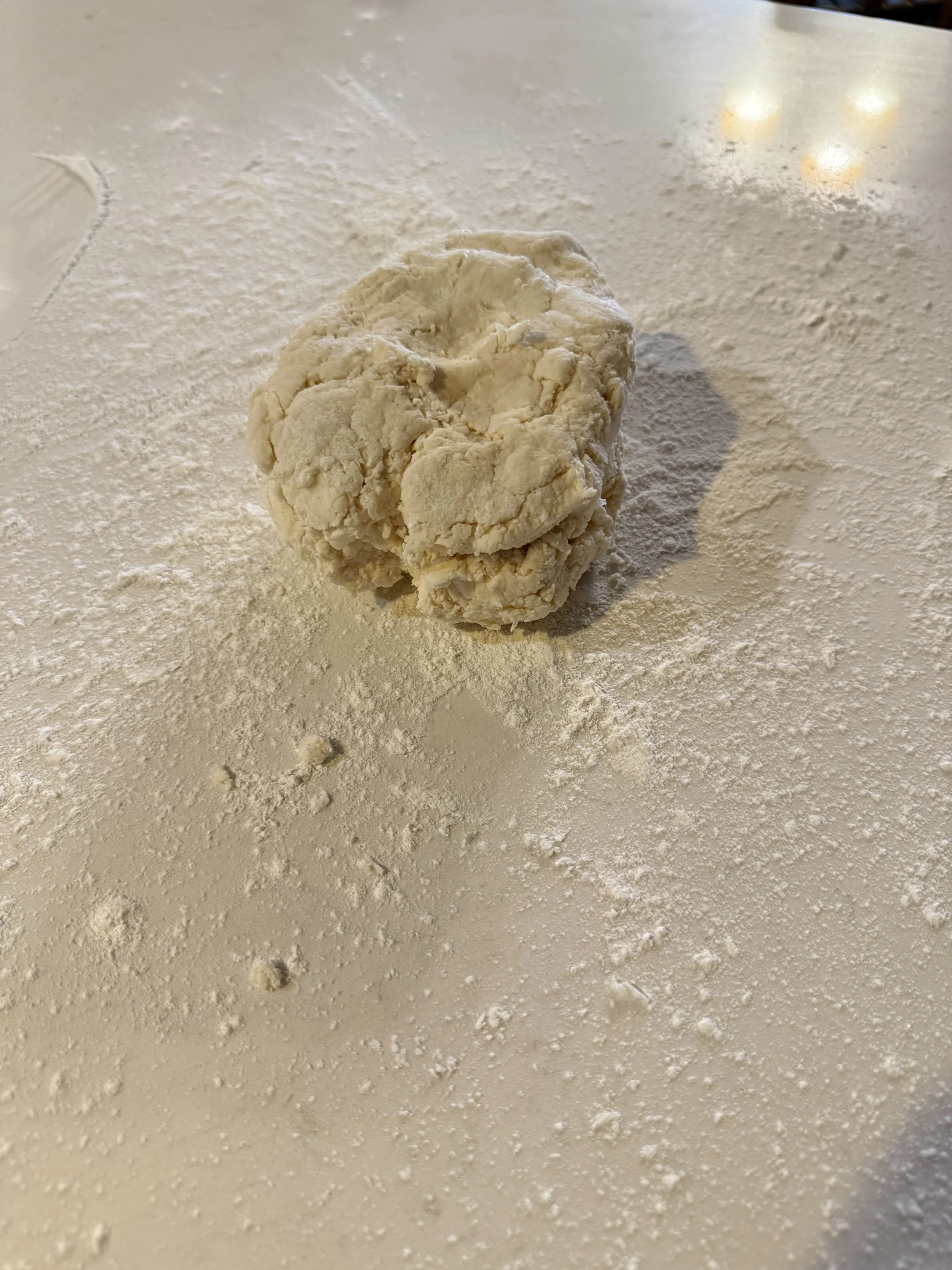 Biscuit dough on a Carrera marble countertop ready for grandma's old fashioned Southern fried apple pies.