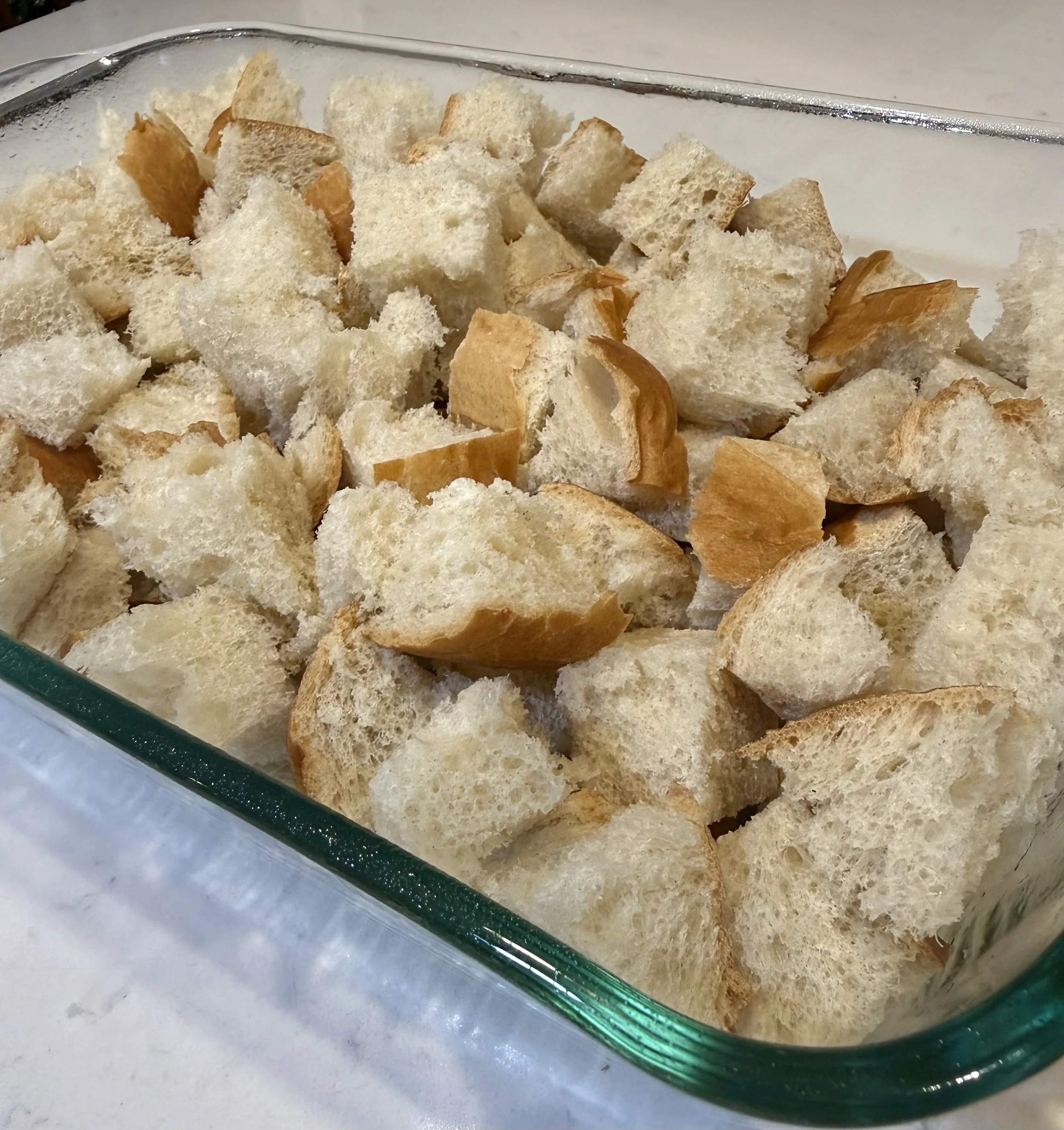 Cubed day old French bread for easy Eggnog Bread Pudding, a holiday spiced version of a classic brunch bake!