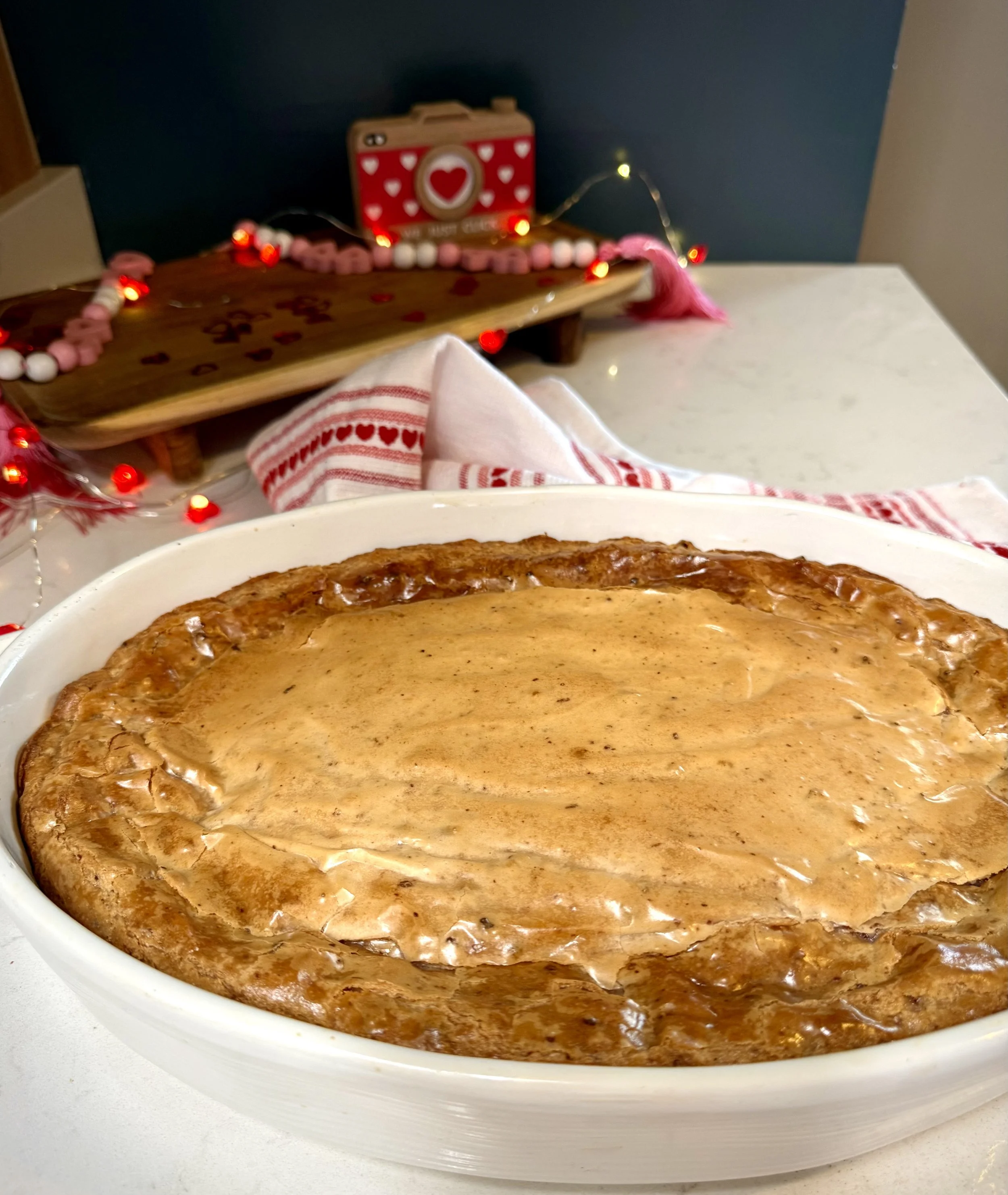 Baked gooey butter strawberry cake ala Paula Deen in a farmhouse kitchen ready to be cut into bars.