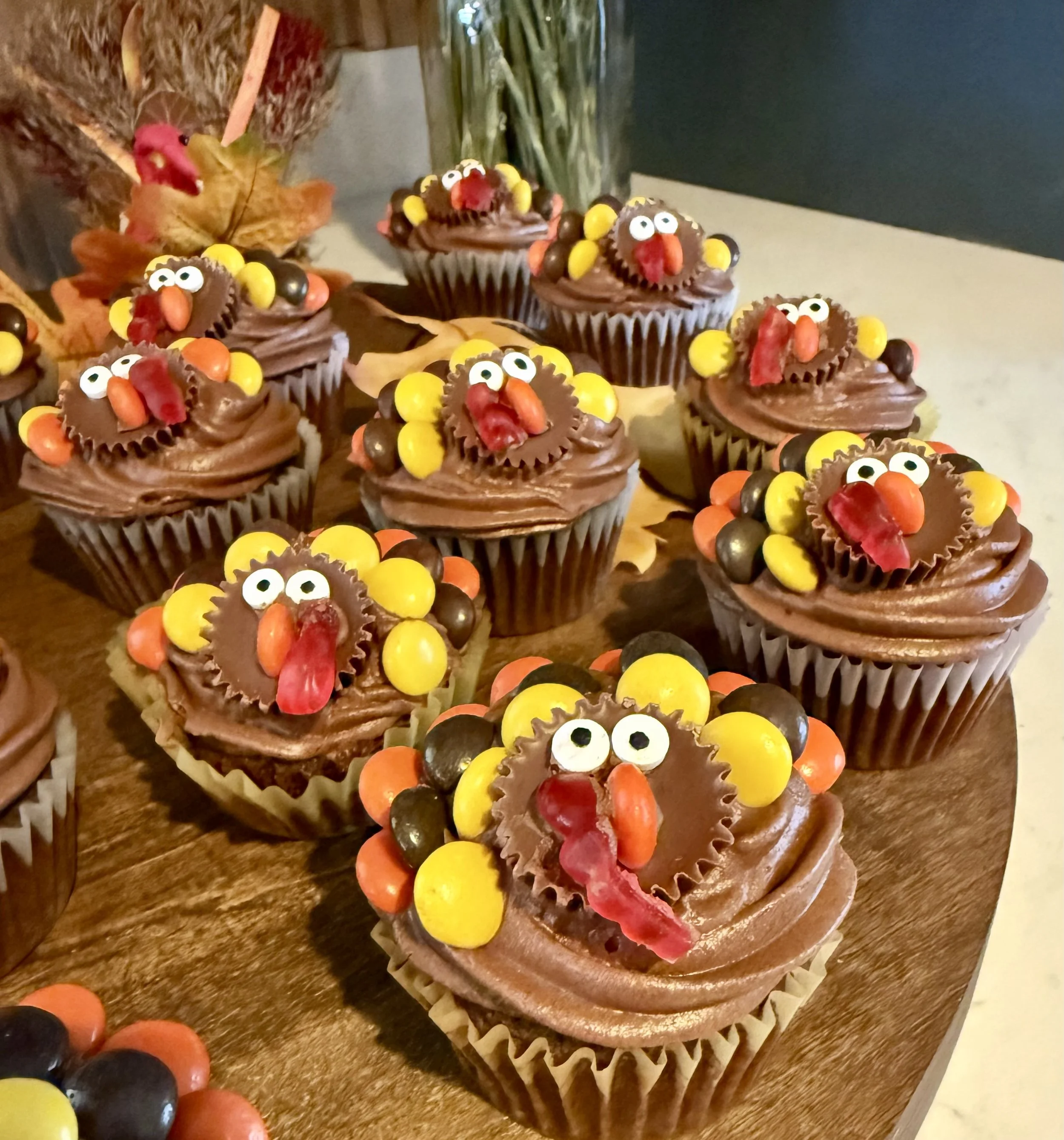 Close up shot of cute decorated turkey cupcakes with a rich chocolate base and decadent chocolate frosting that are too cute and festive to eat!
