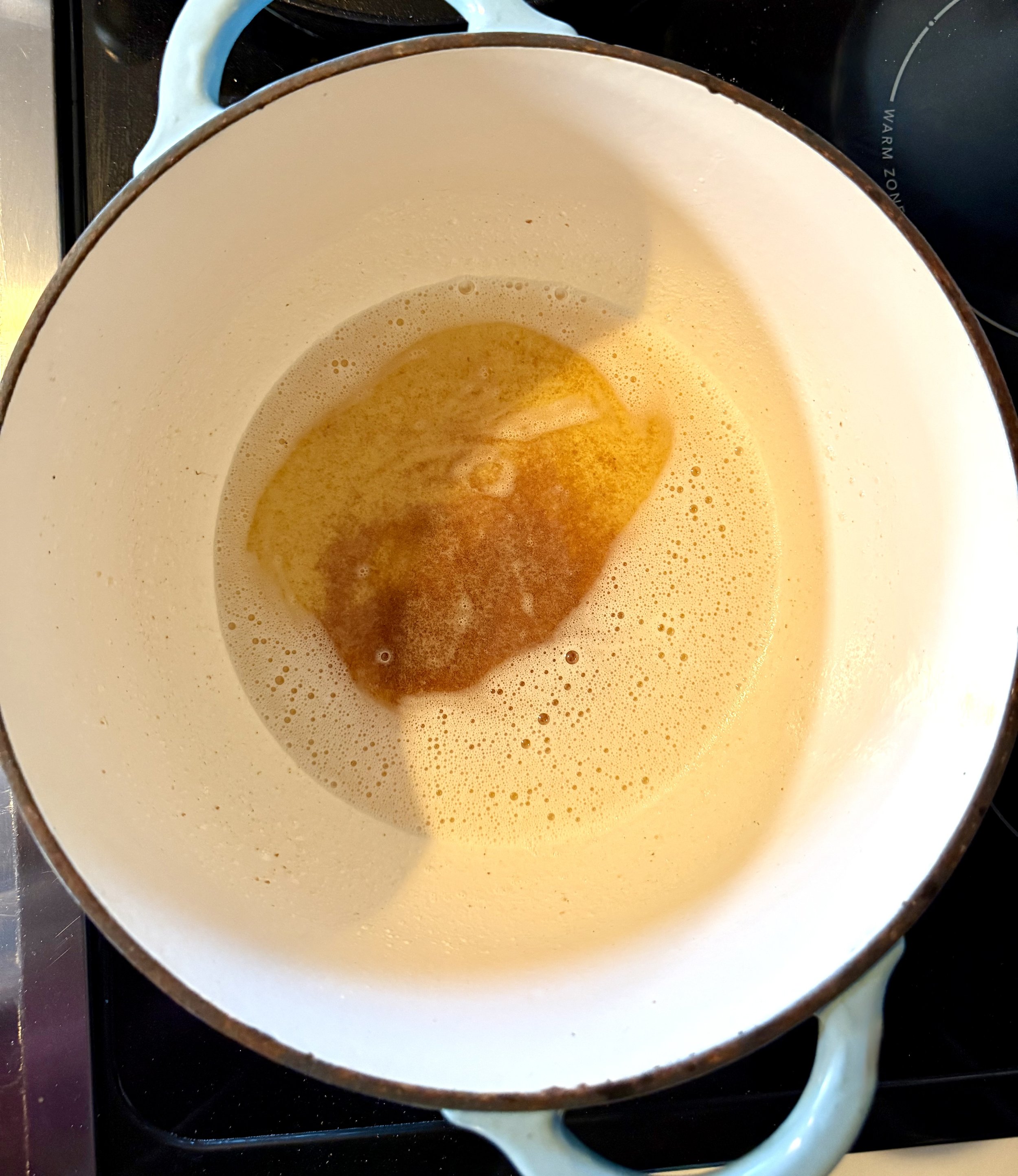 Melted browned butter in a cast iron skillet before adding chocolate cobbler batter.