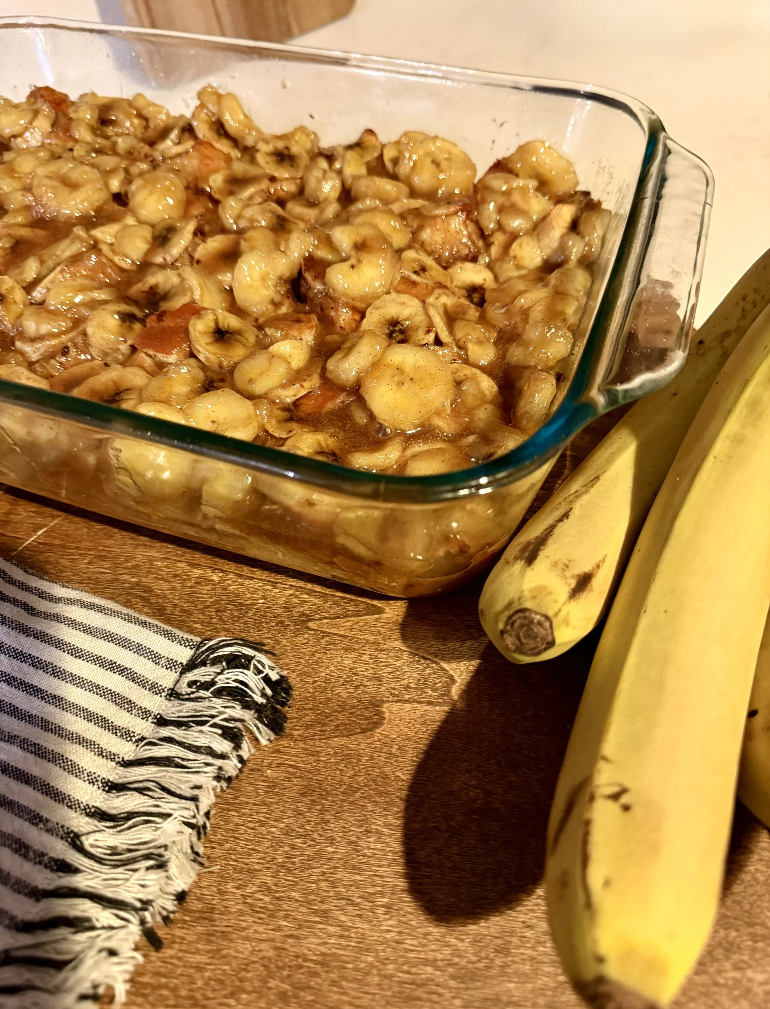 Close up picture of bananas foster bread pudding before being spooned onto a place-it's a beautiful, warm, buttery, rich SOuthern dessert.