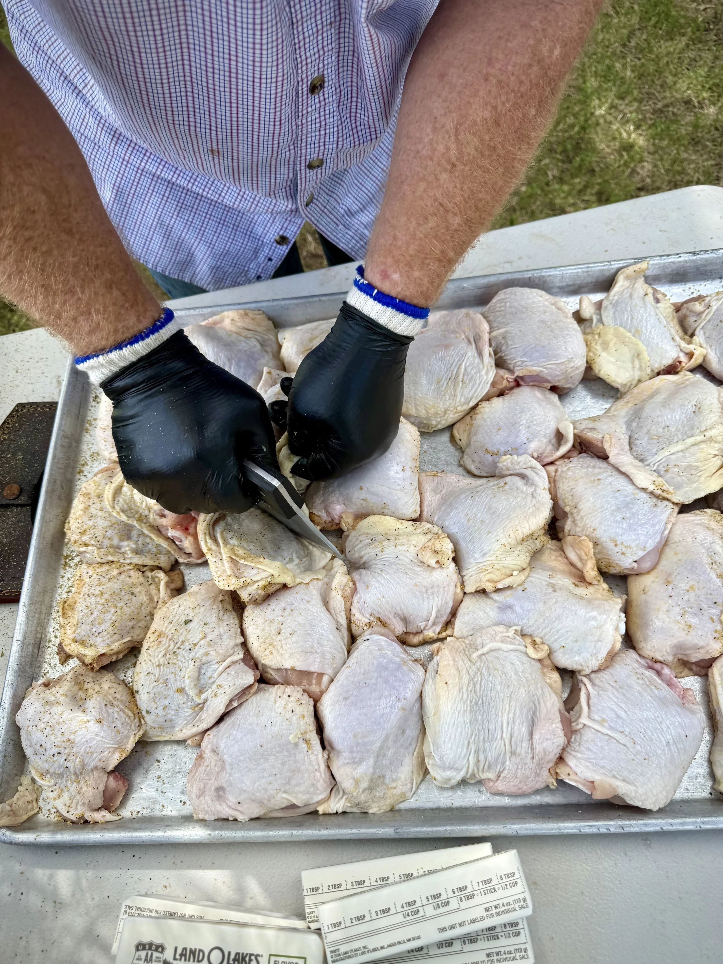 Trimming chicken thighs for the ultimate smoked chicken experience.