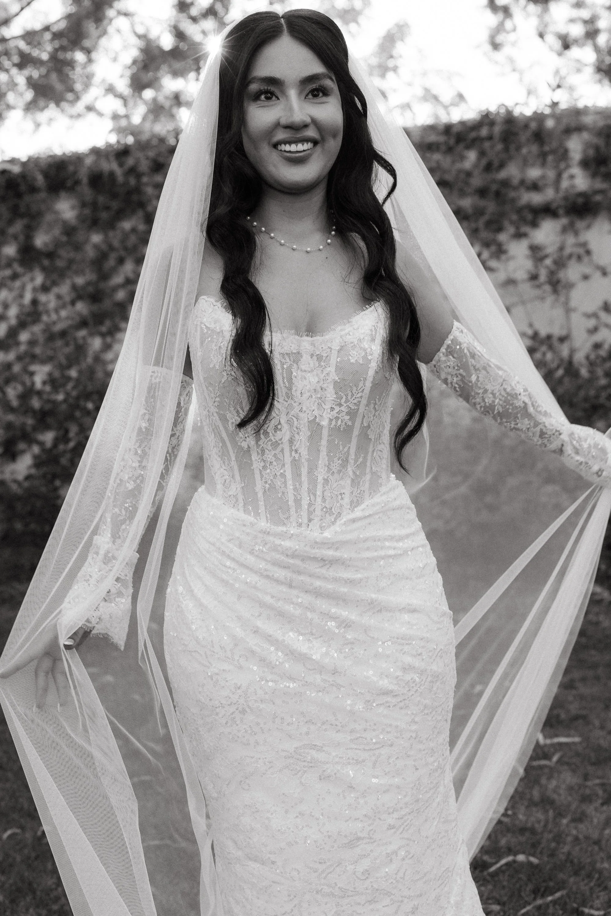 Black and white bridal portrait with lace gown and veil at Los Angeles River Center and Gardens.
