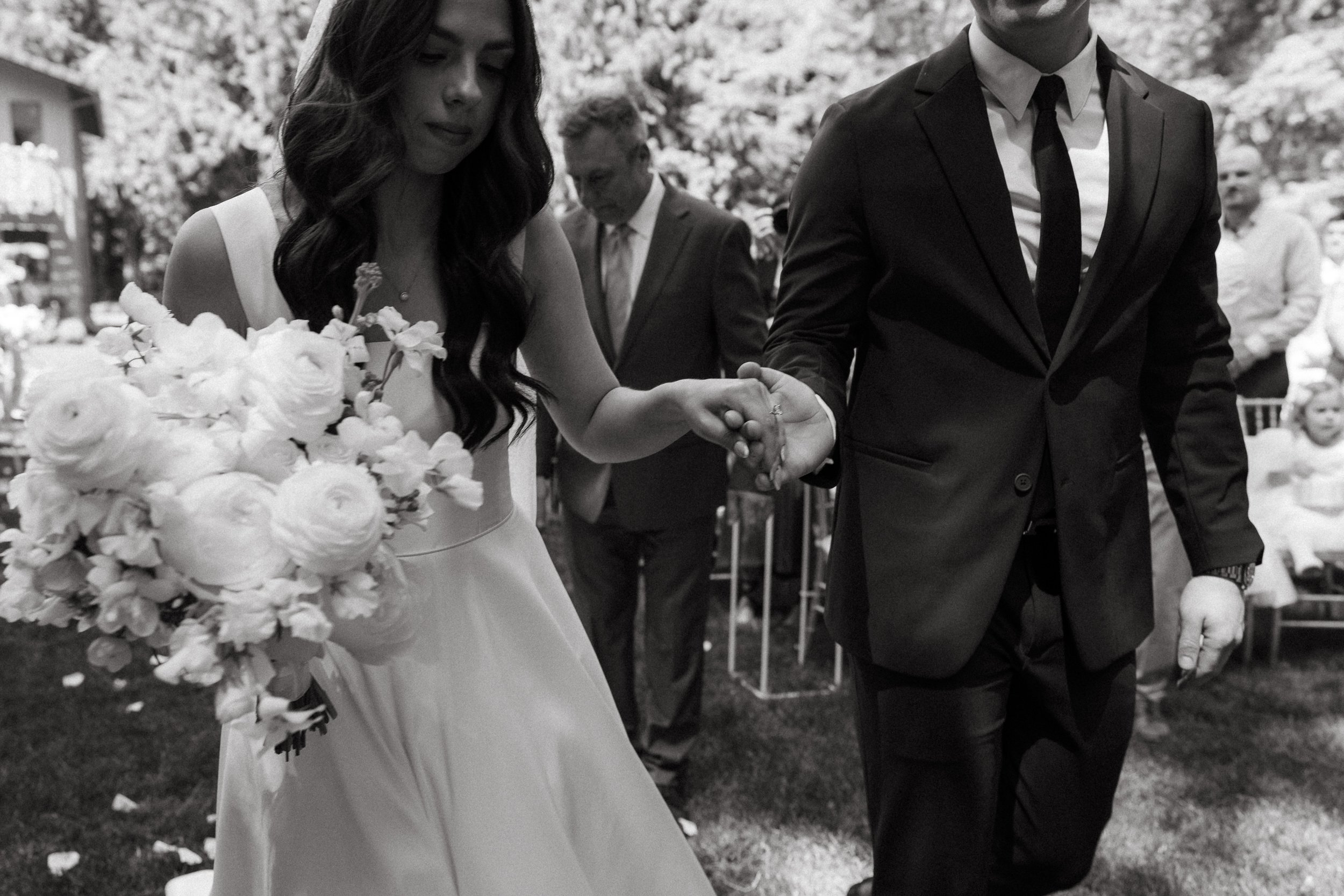Bride and groom holding hands for the first time during the ceremony processional.