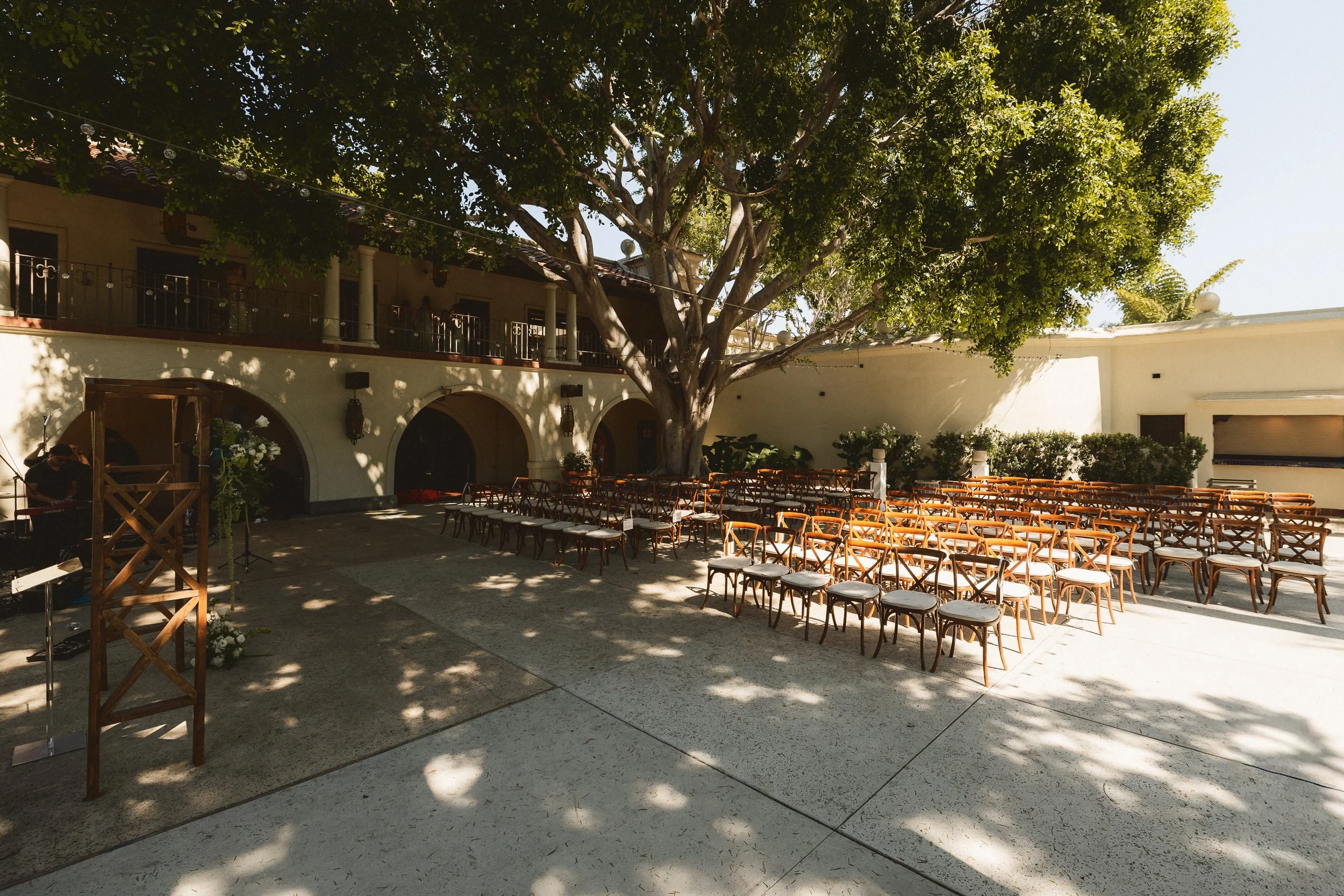 Courtyard ceremony space under trees at Los Angeles River Center and Gardens