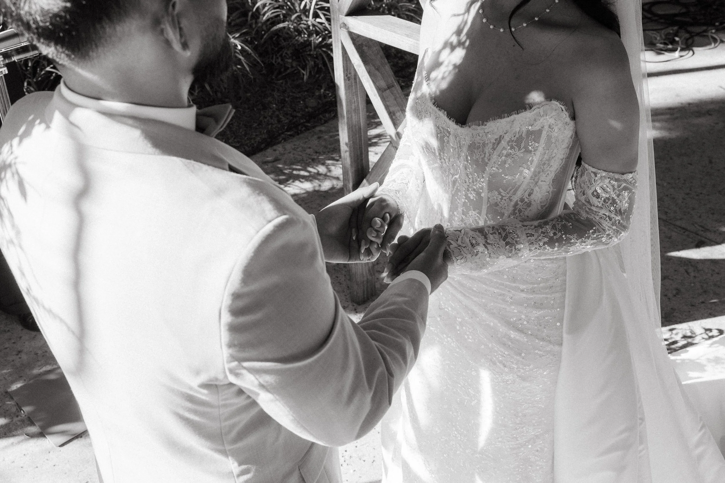 Close-up of bride and groom holding hands during vows at Los Angeles River Center and Gardens.