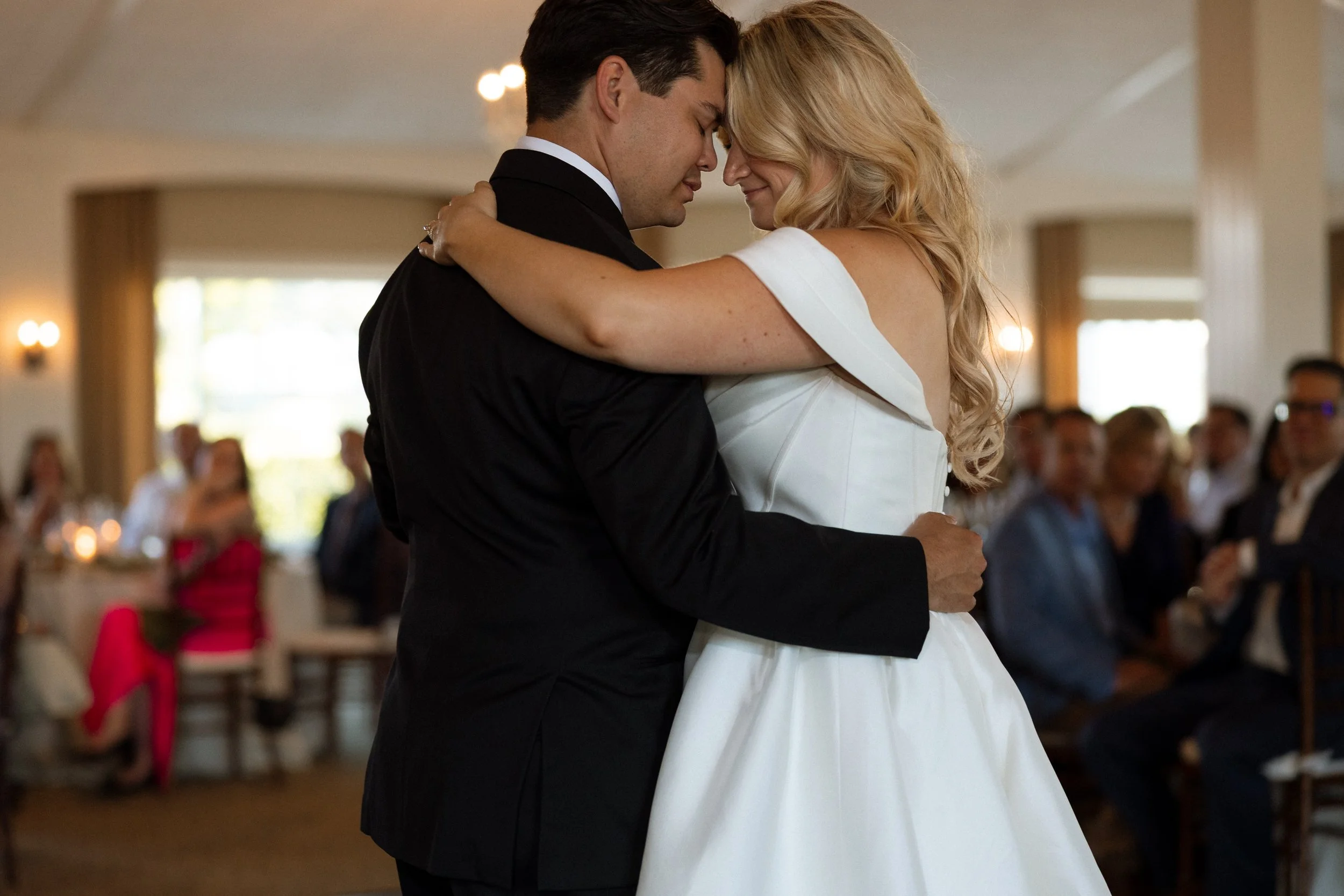 Groom and bride rest foreheads together during an intimate first dance