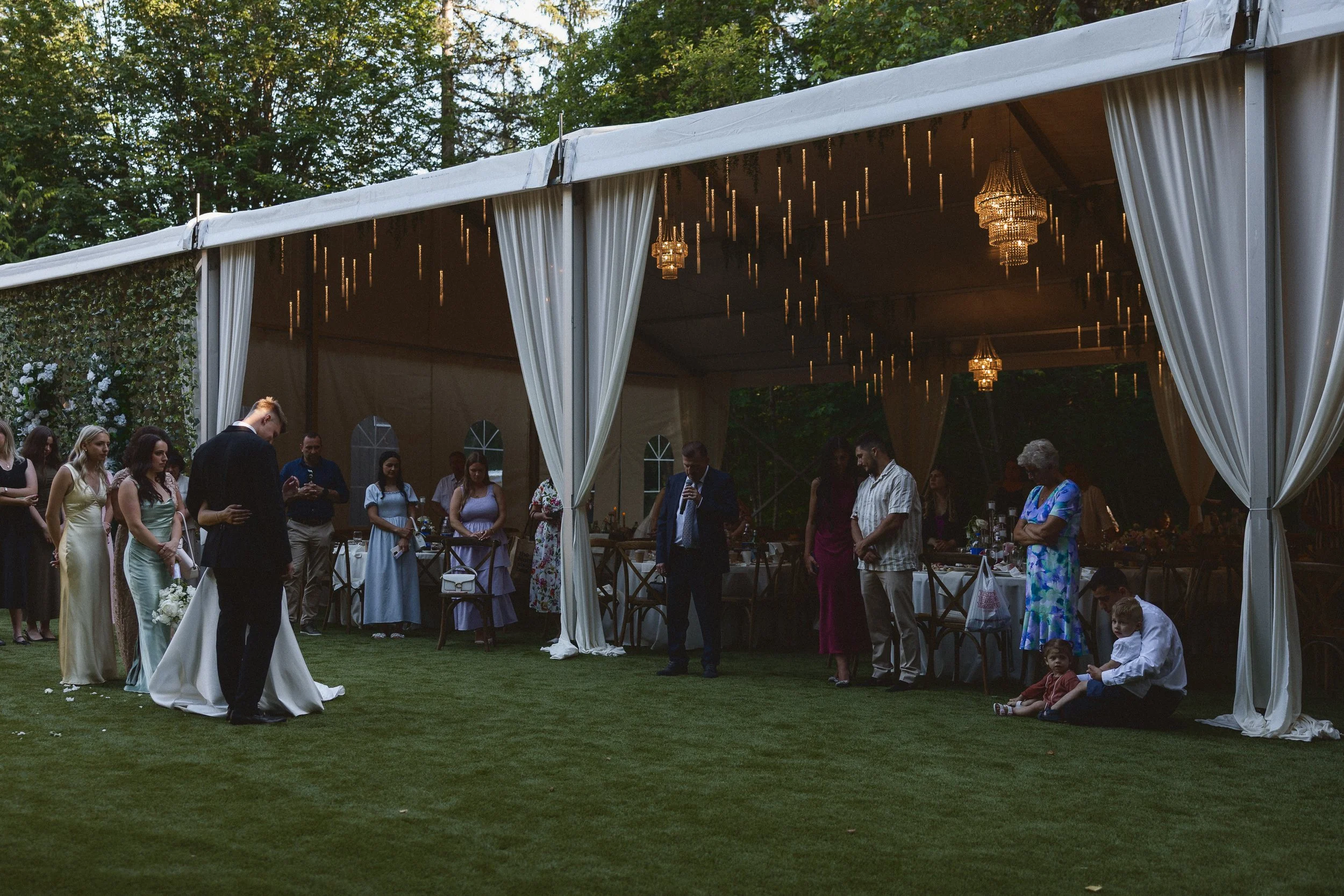 Guests gather around lawn during evening reception