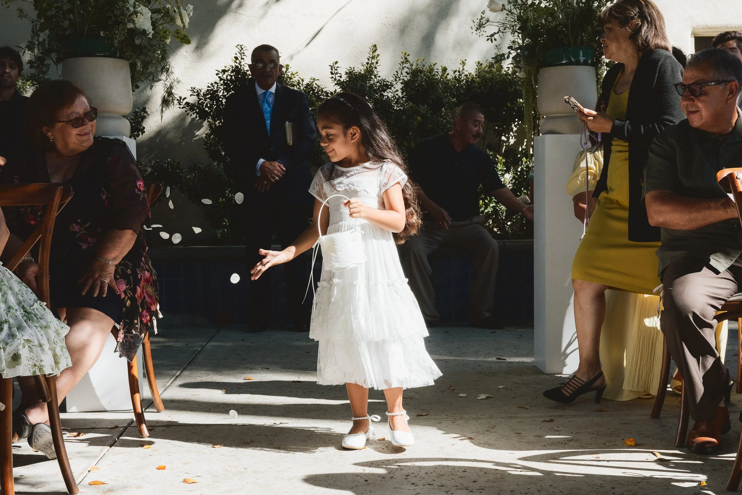 Flower girl tossing petals down the aisle at Los Angeles River Center wedding