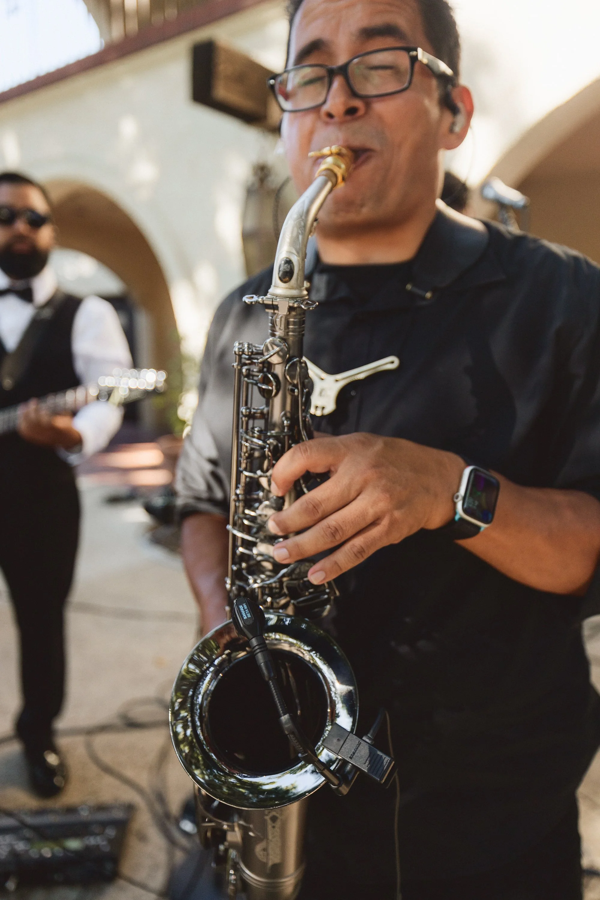 Musician playing saxophone during live worship at Los Angeles River Center wedding