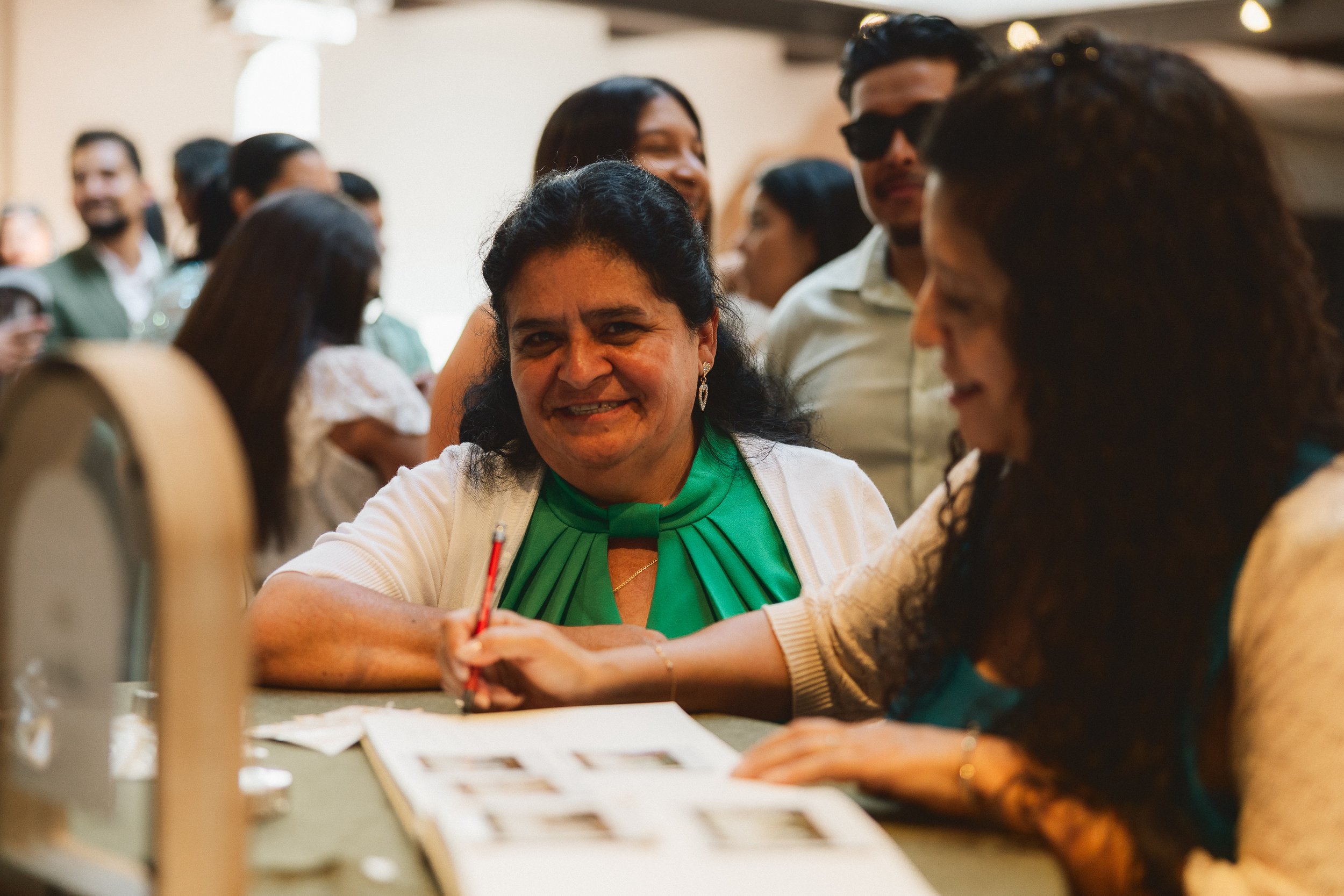 Guests signing wedding guest book during reception at Los Angeles River Center