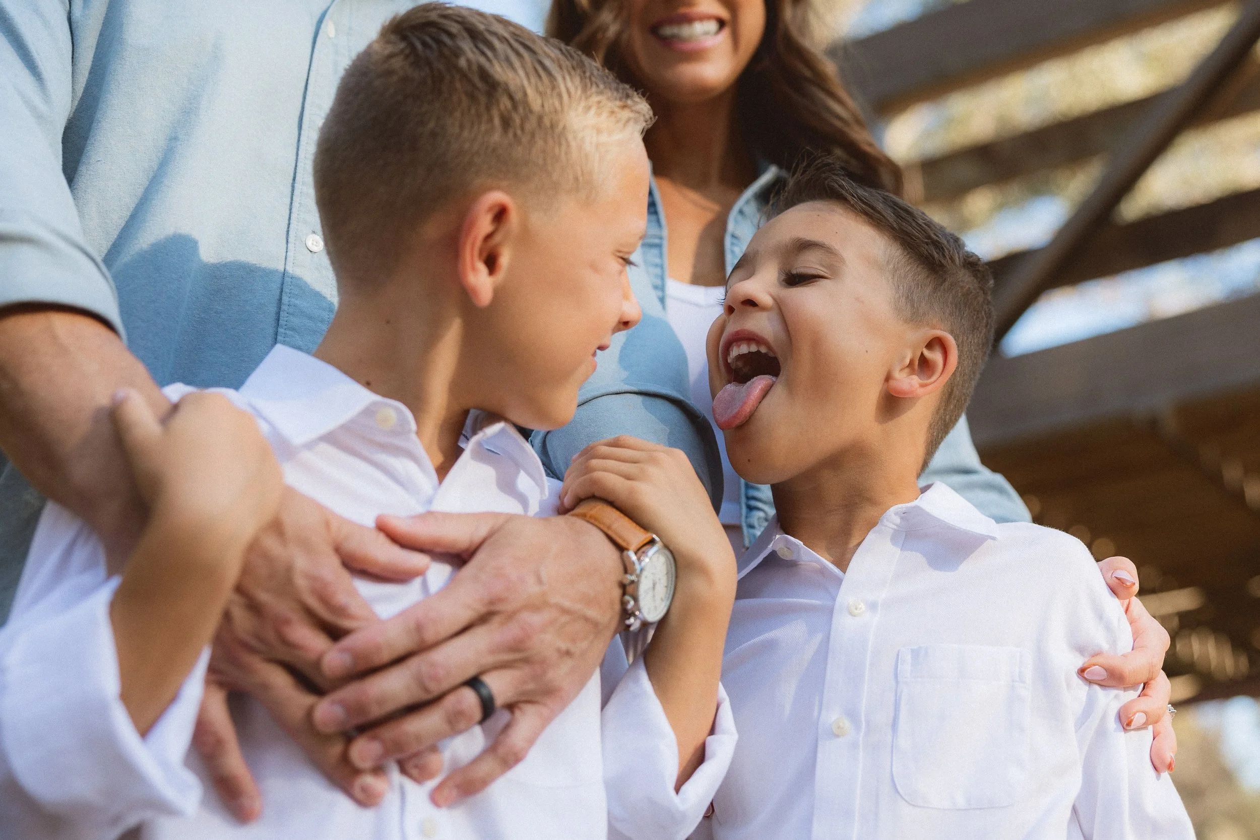 Young kid sticking his tounge out at his brother.