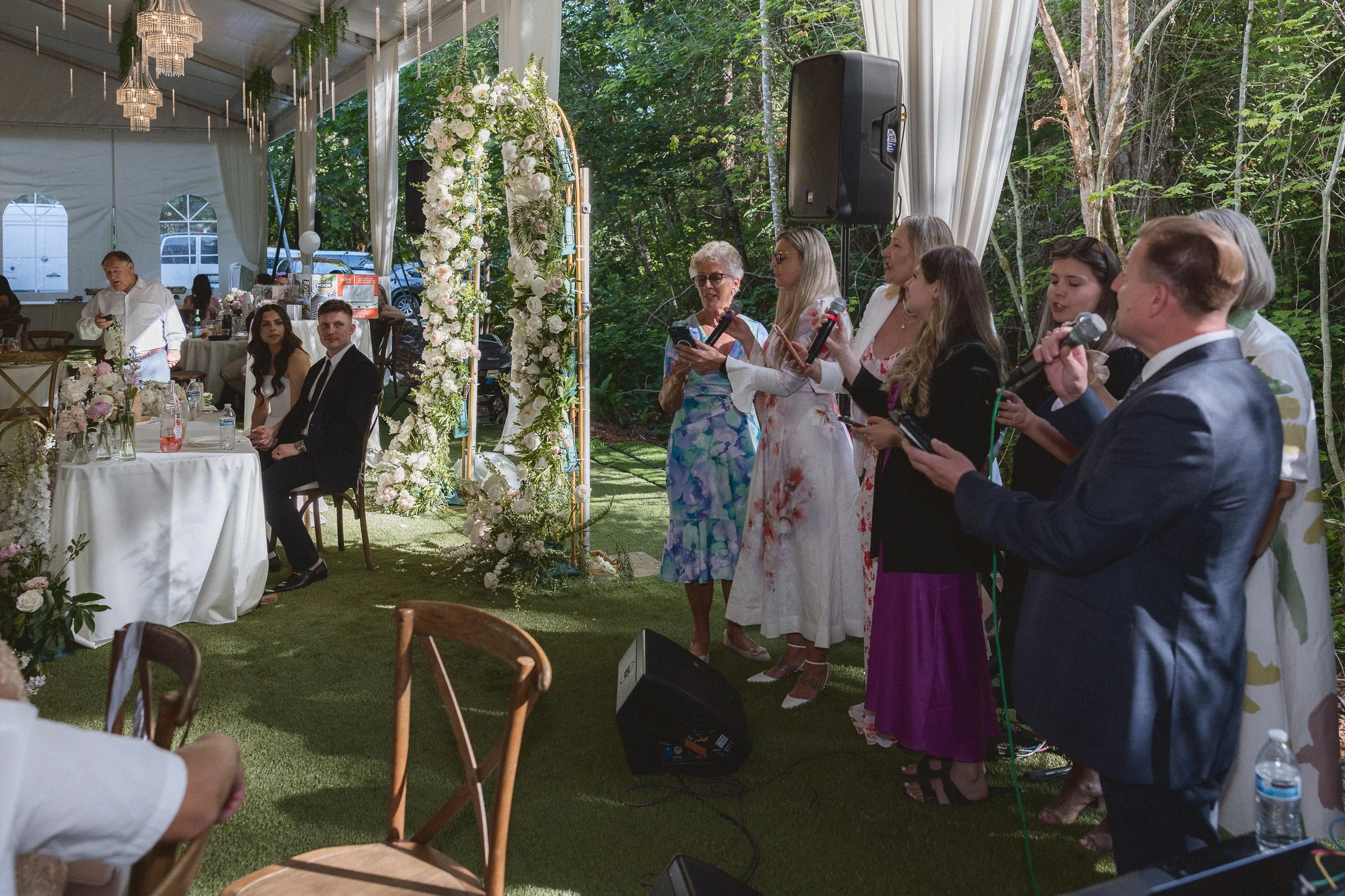 edding guests sing and perform a group song during the reception