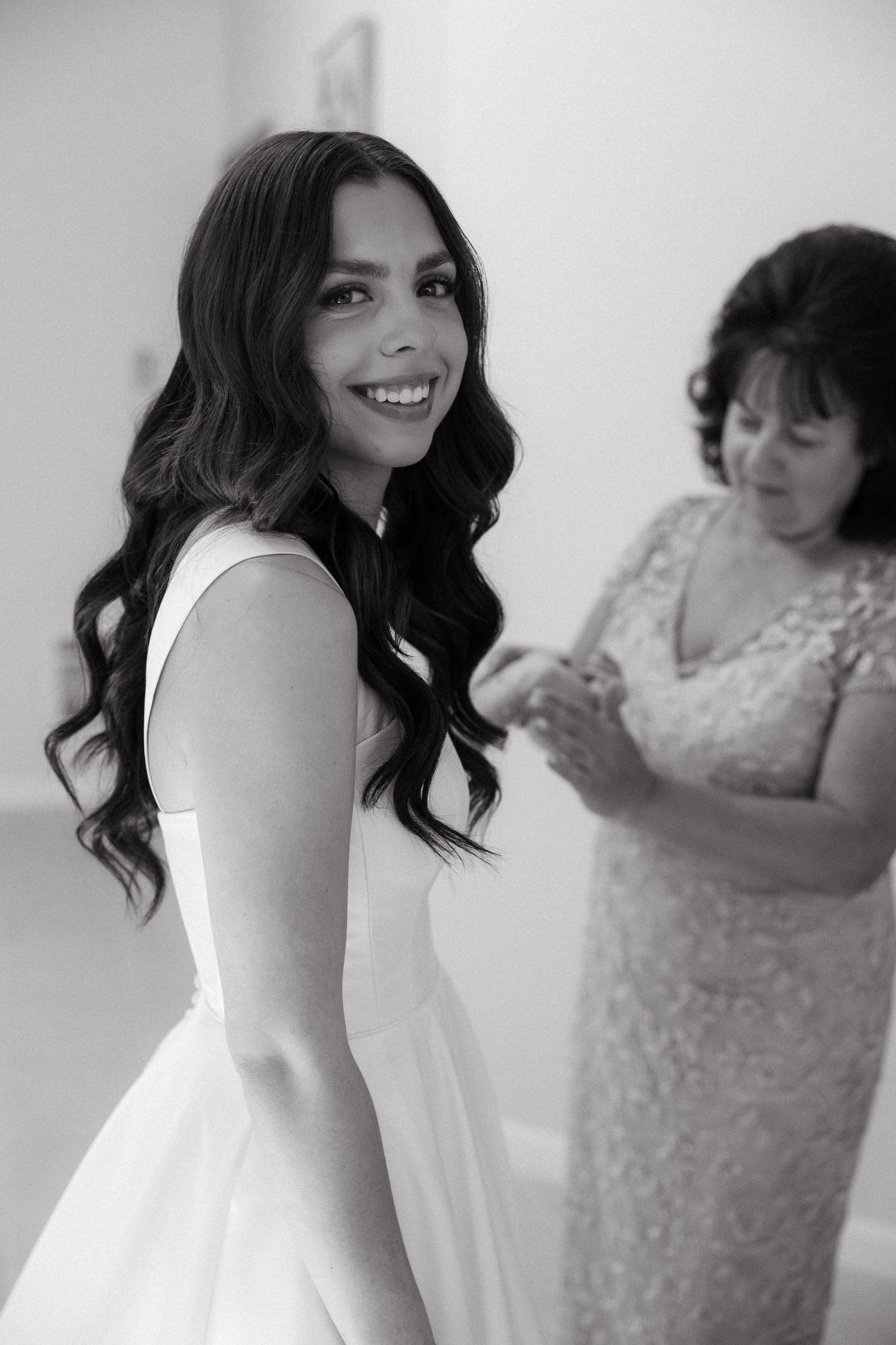 Angie smiling while getting ready in her dress at Hidden Stone Palace in Bonney Lake.