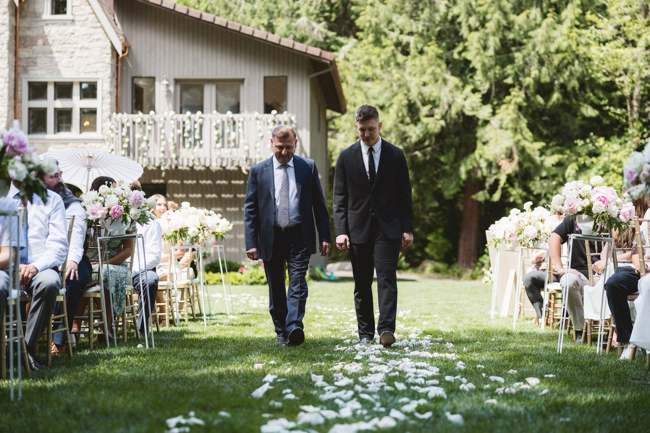 The groom and his dad walking side by side down the aisle.