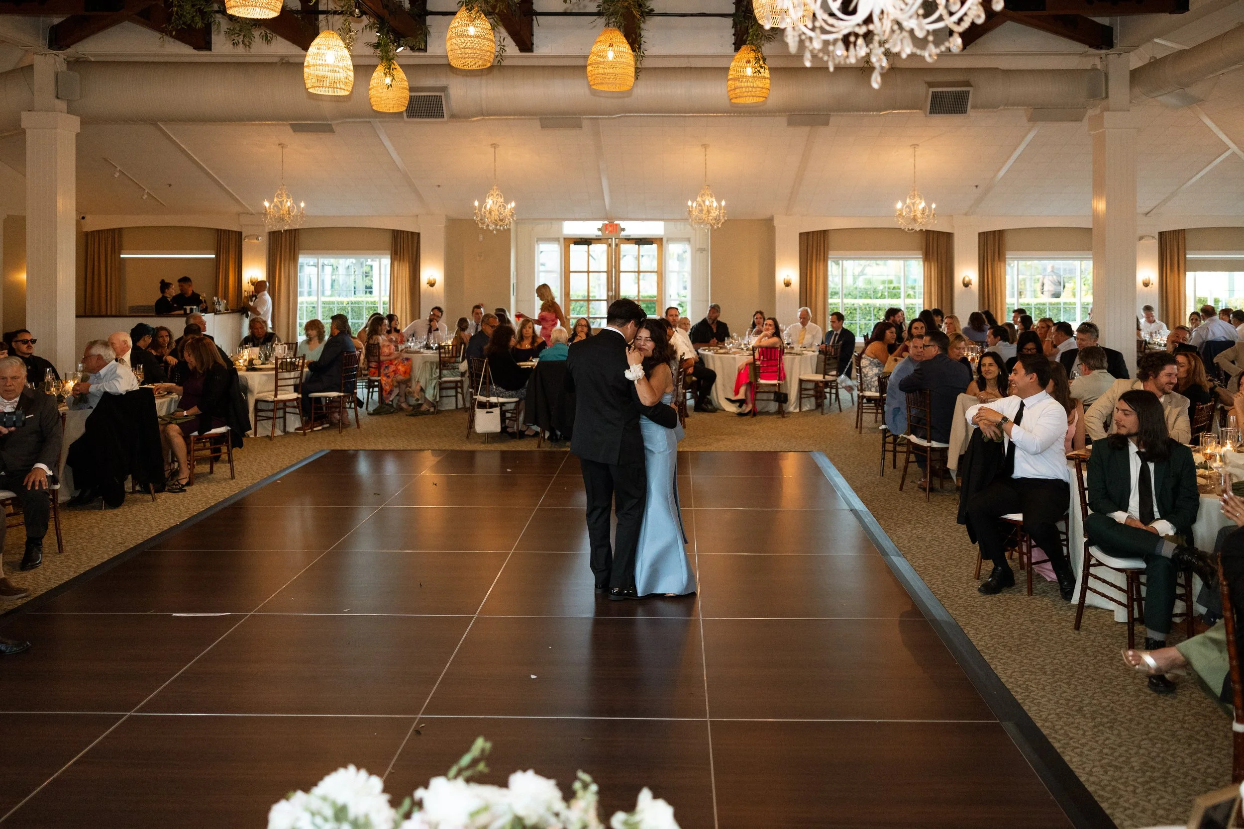 Groom dances with his mother in the center of the reception floor