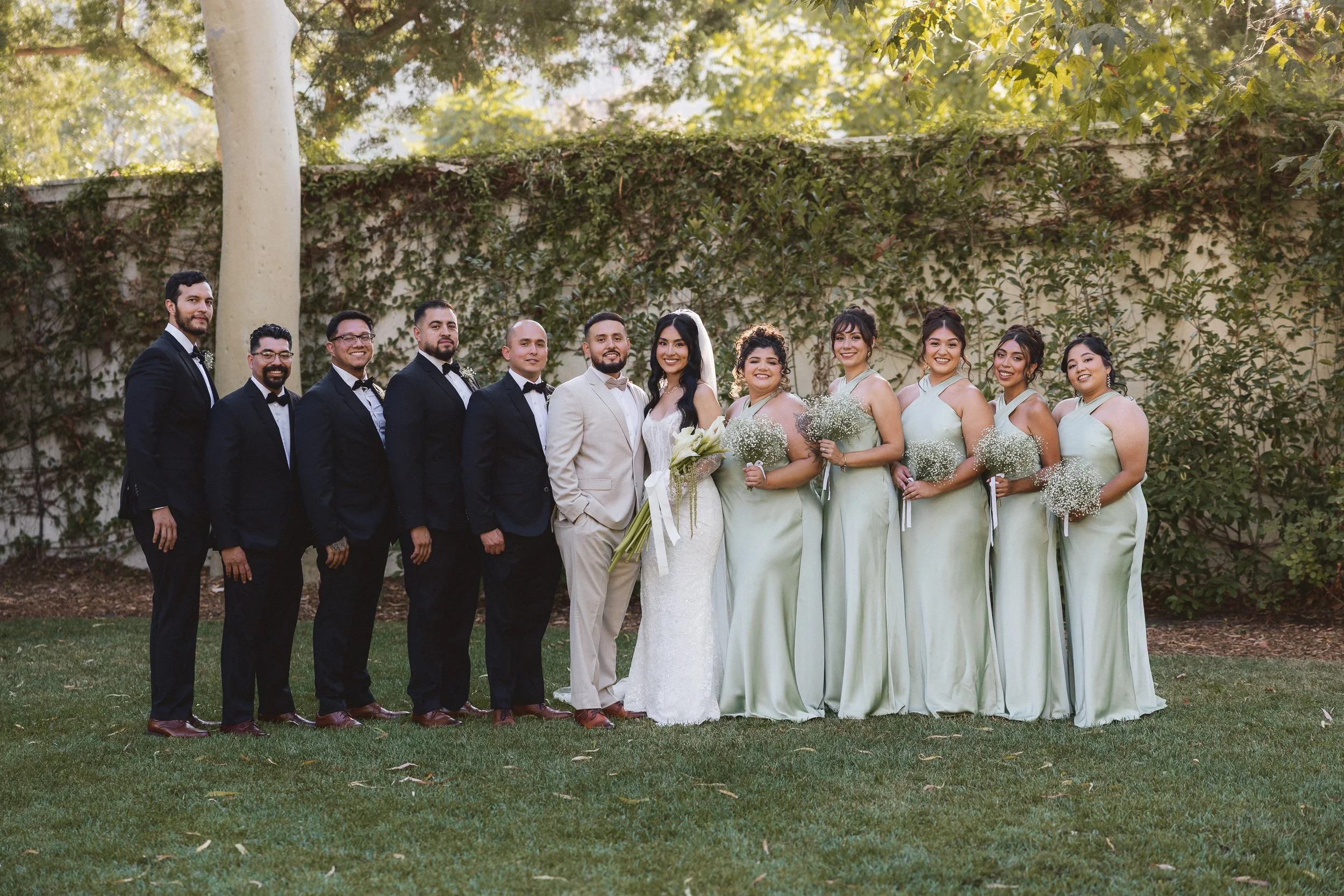 Full wedding party group photo with groomsmen and bridesmaids at Los Angeles River Center and Gardens.