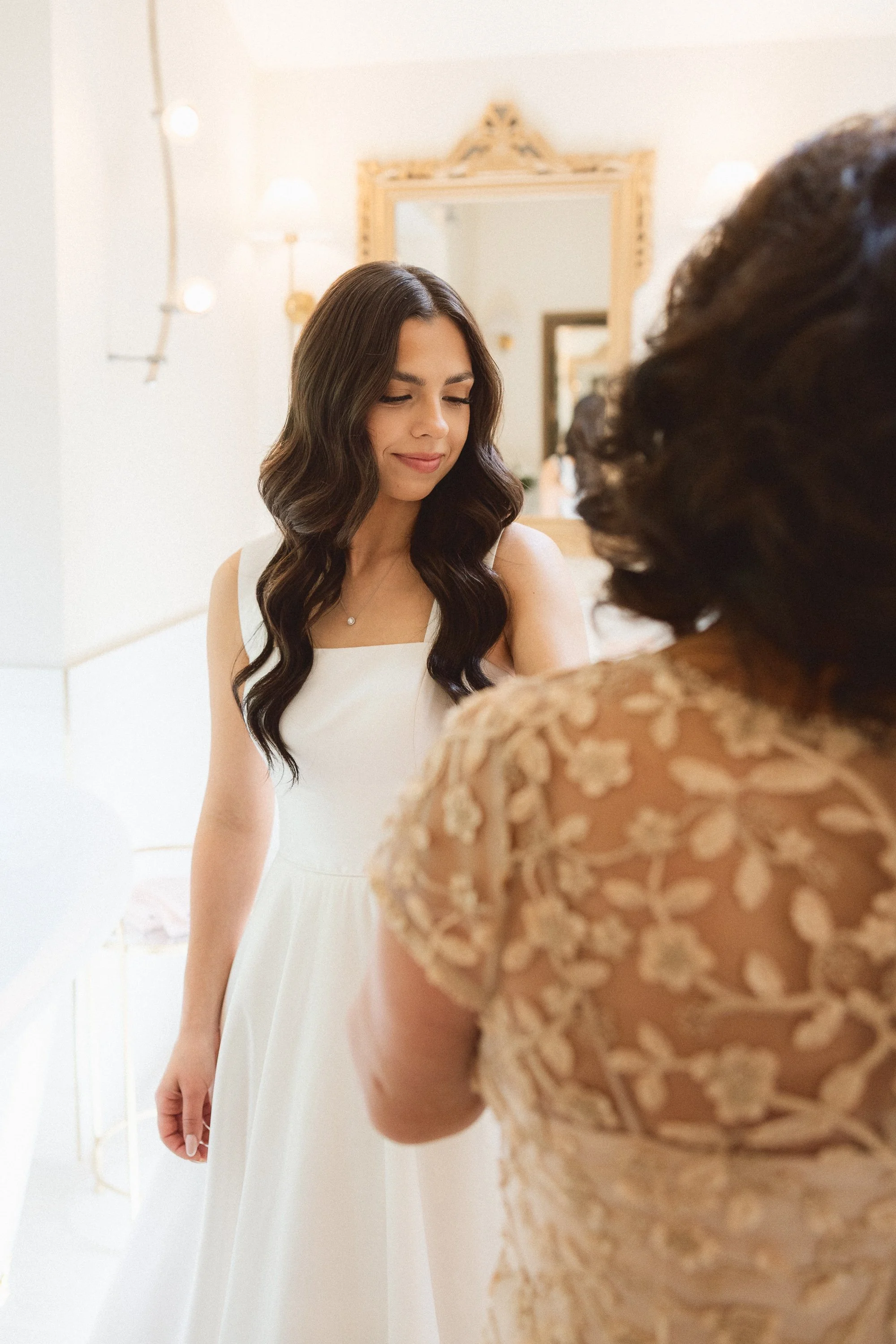 Bride standing in front of mirror during getting ready at Hidden Stone Palace in Bonney Lake.