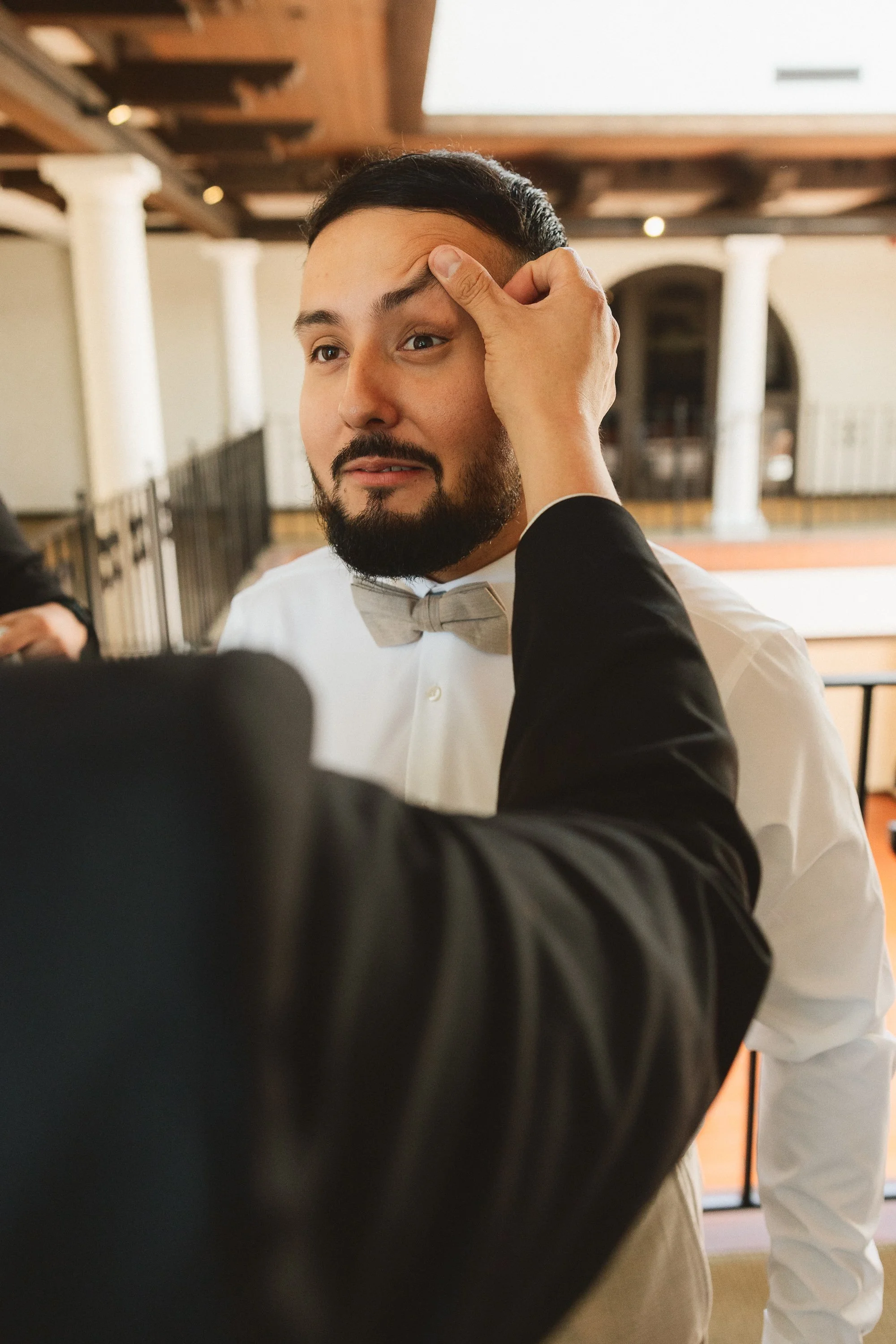 Groom having final touches done before Los Angeles River Center wedding