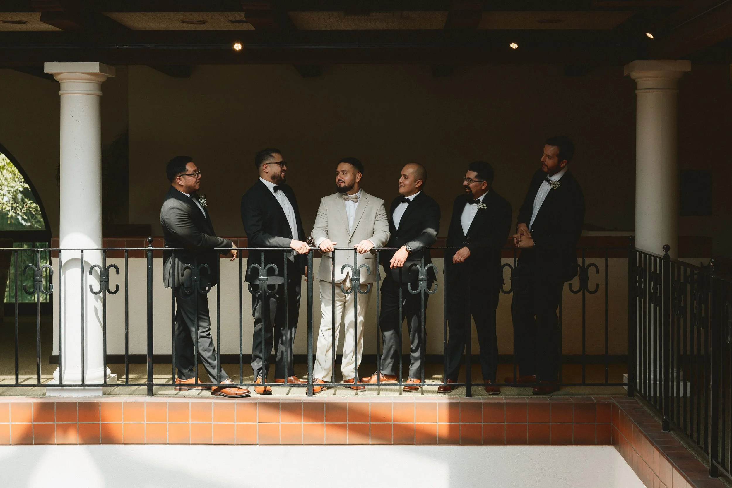 Groom with groomsmen lined up on balcony at Los Angeles River Center