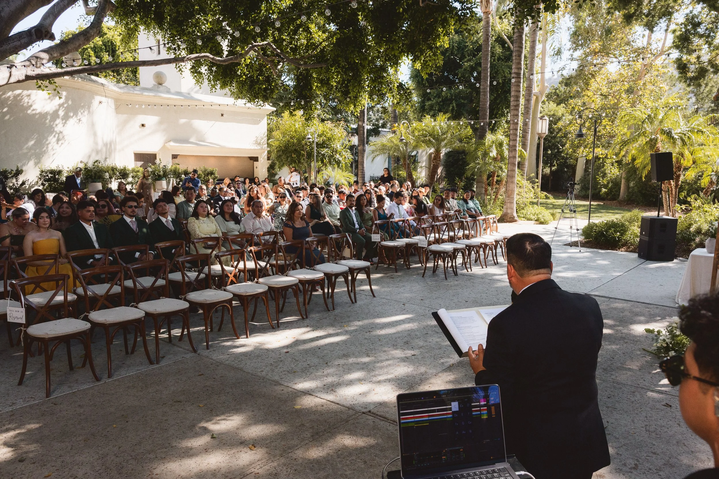 Guests seated outdoors before wedding ceremony at Los Angeles River Center