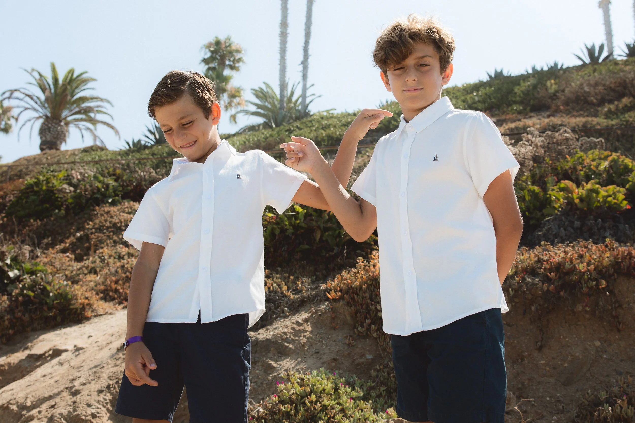 Two brothers teasing each other during candid family photos in Orange County.