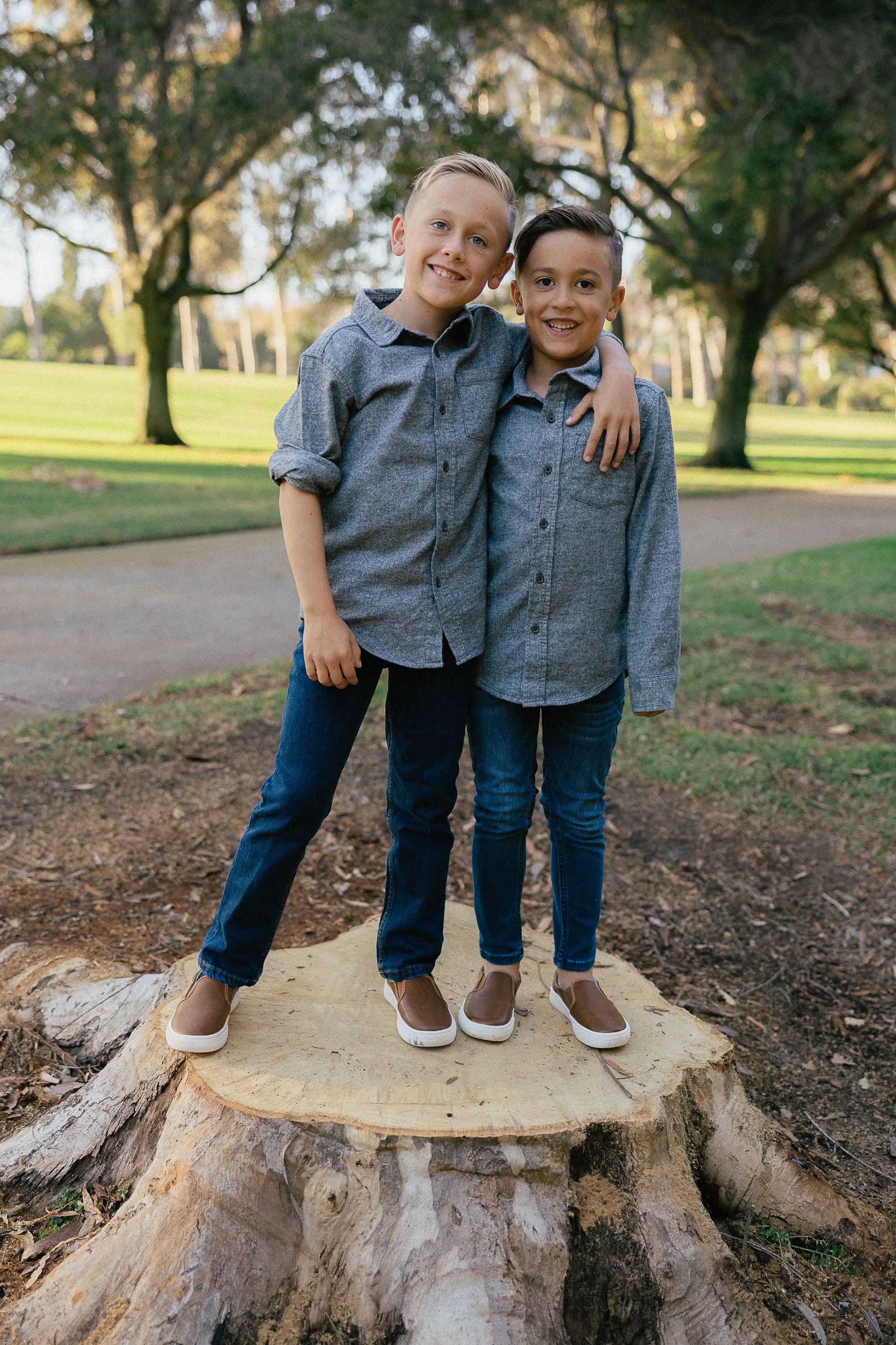 Two brothers standing with arms around each other at Turtle Rock Community Park.