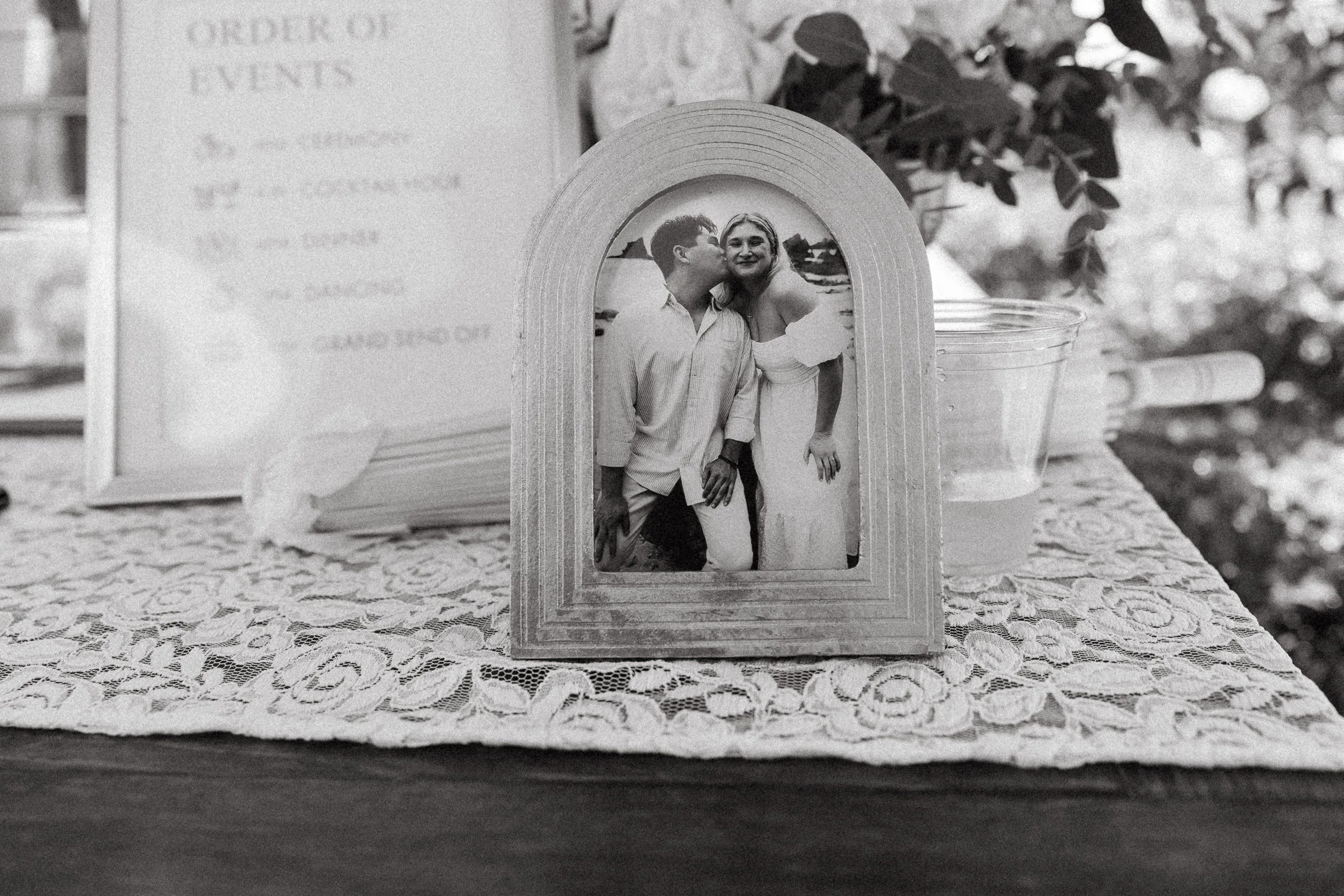 Framed photo of the couple displayed beside the order-of-events sign