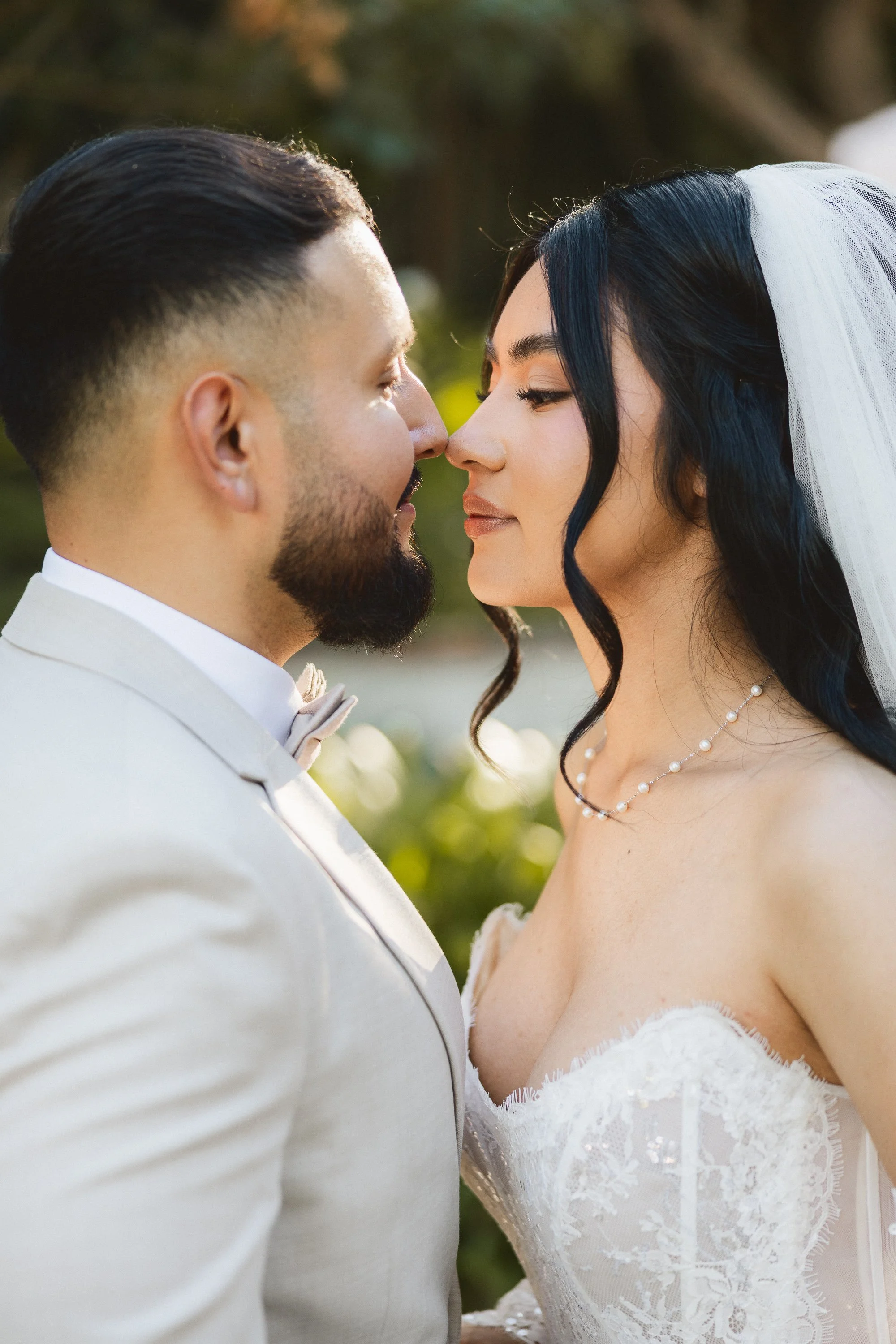 Close-up of bride and groom sharing a romantic moment in the gardens at Los Angeles River Center.