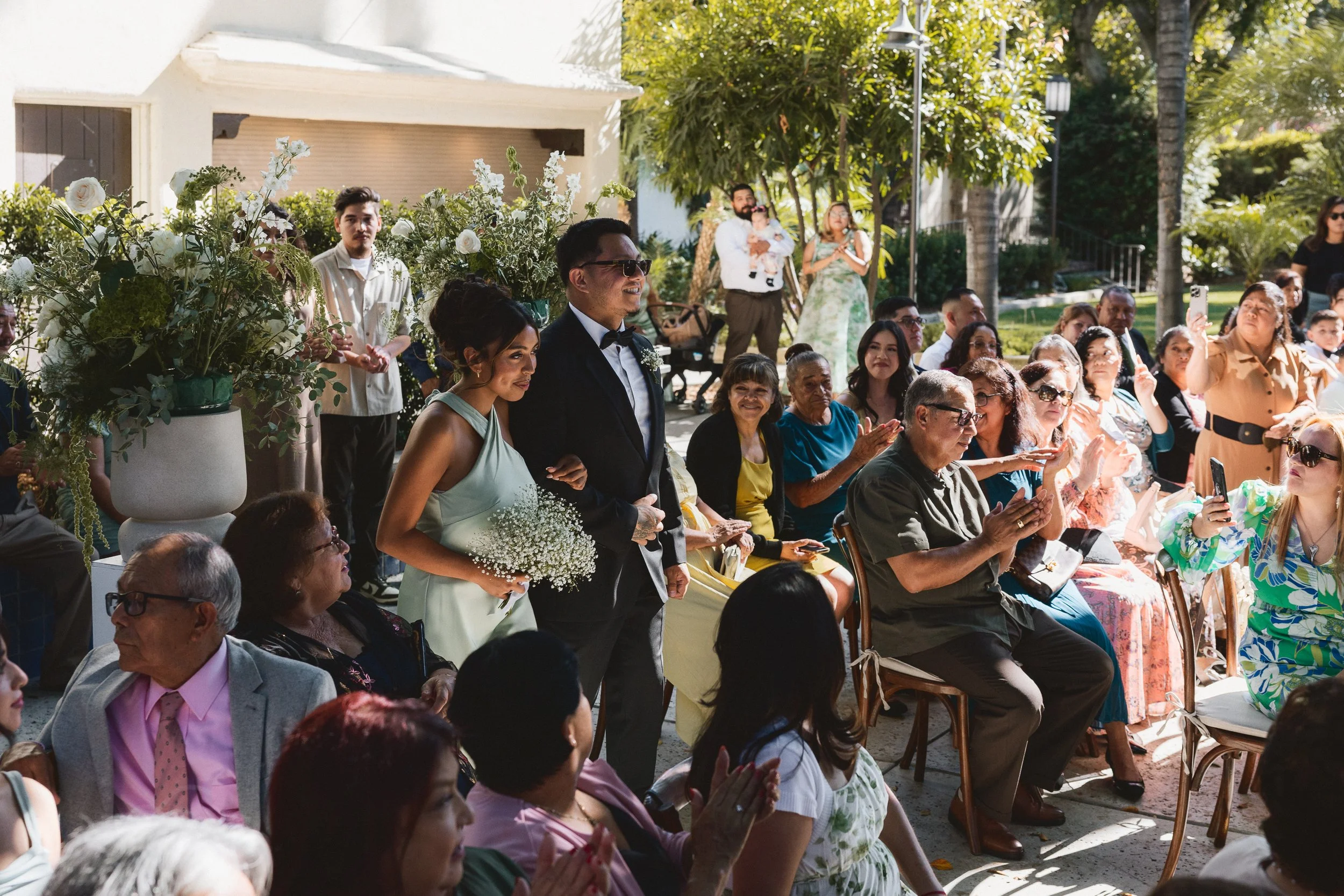 Bridesmaid and groomsman walking down the aisle during ceremony processional