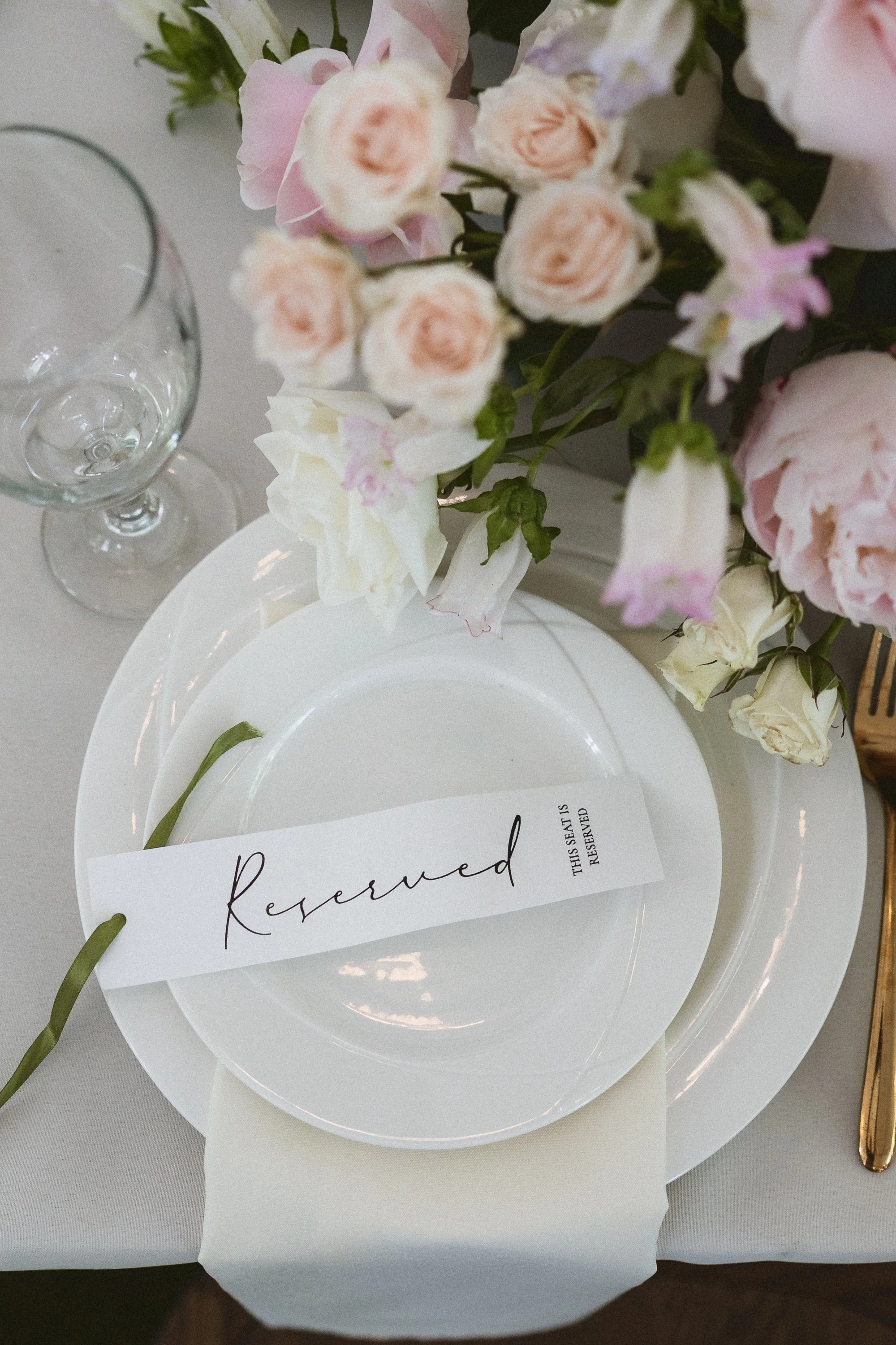 Reserved place setting with delicate florals and handwritten name card