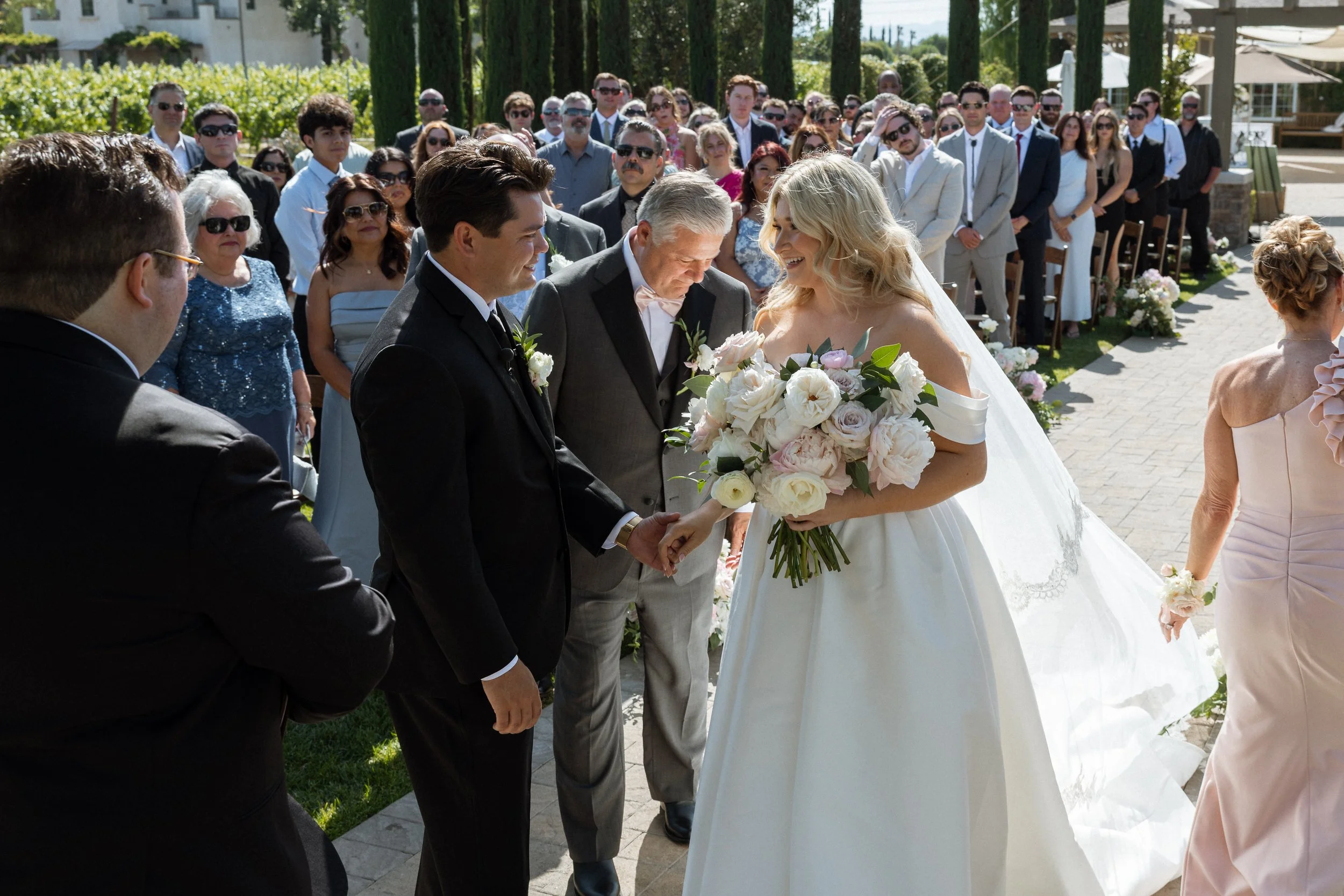 Bride's father hands her to the groom at the front of the ceremony