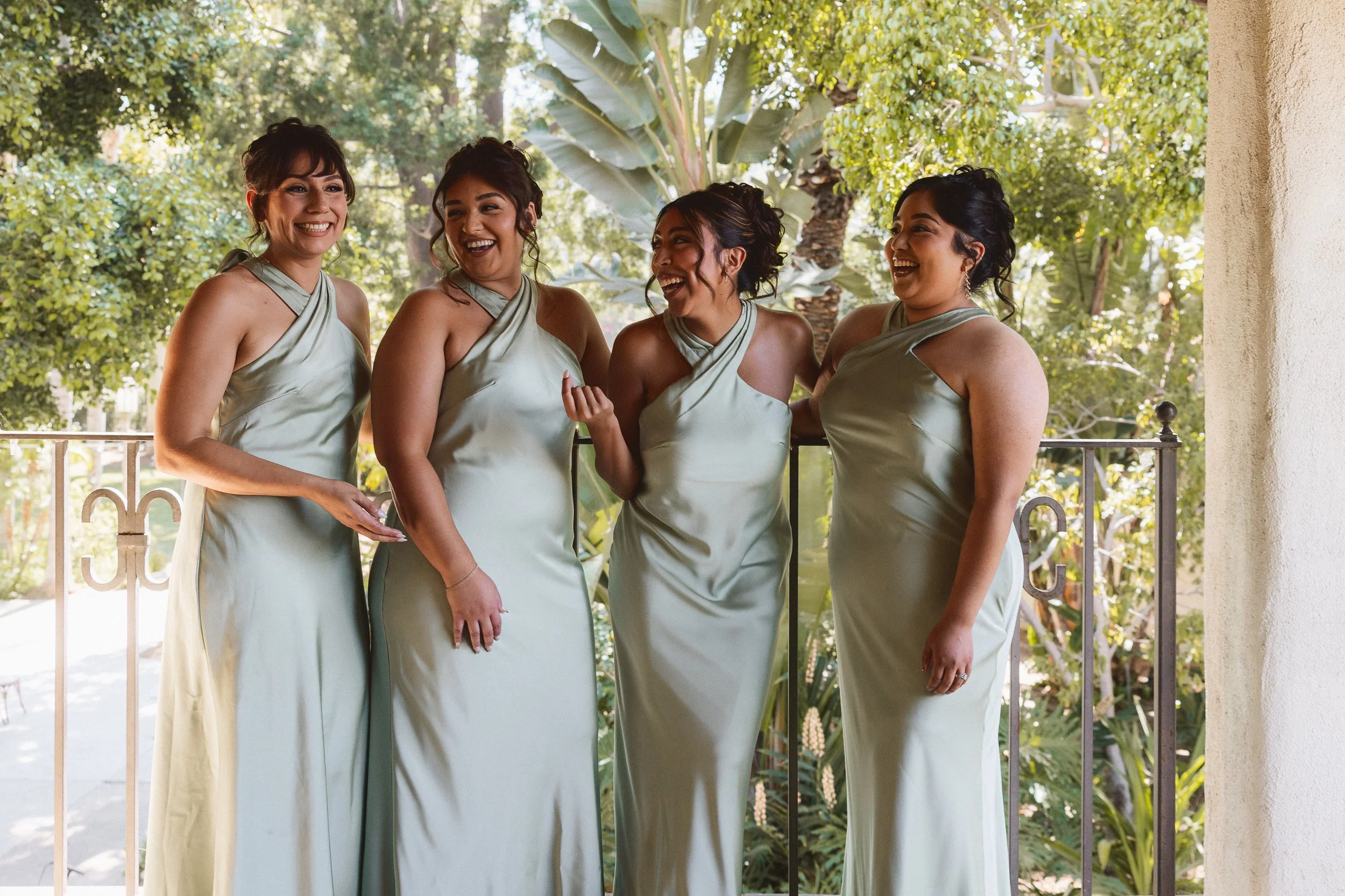 Bridesmaids laughing together in outdoor portraits before ceremony