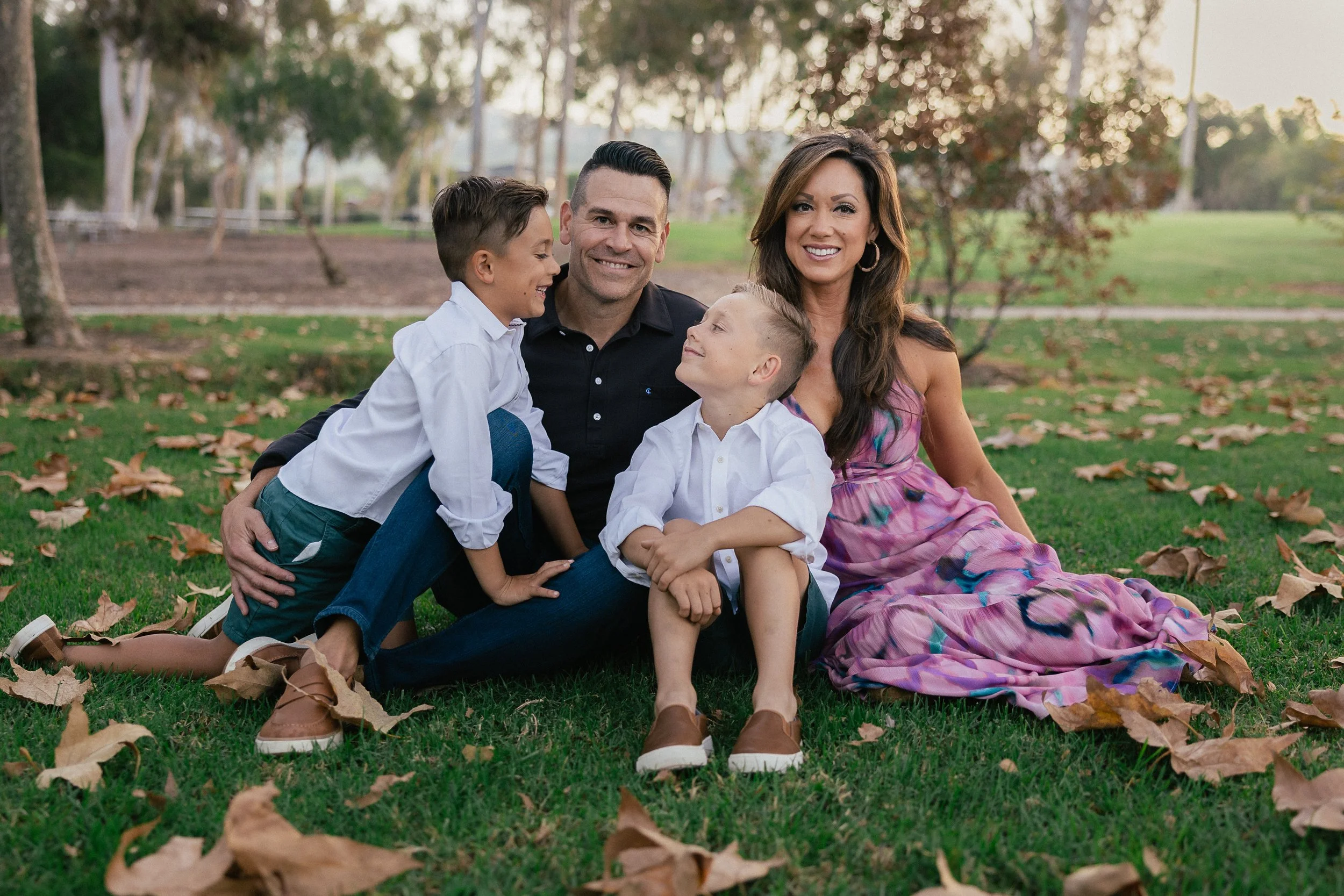 family sitting together on the grass during turtle rock community park family photos in irvine ca