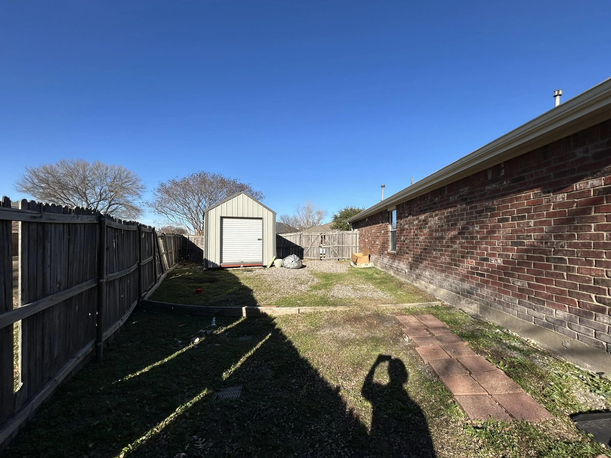 Before picture of shed area of a Rowlett property