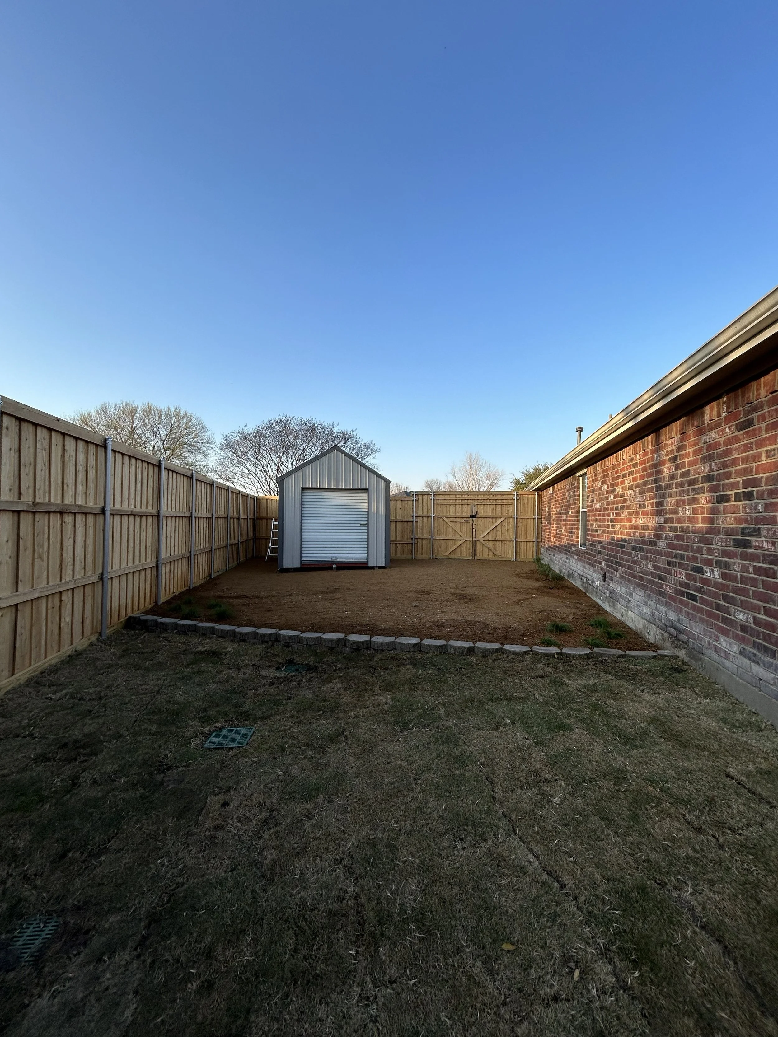 After photo of shed area with clean gravel and fresh new plants