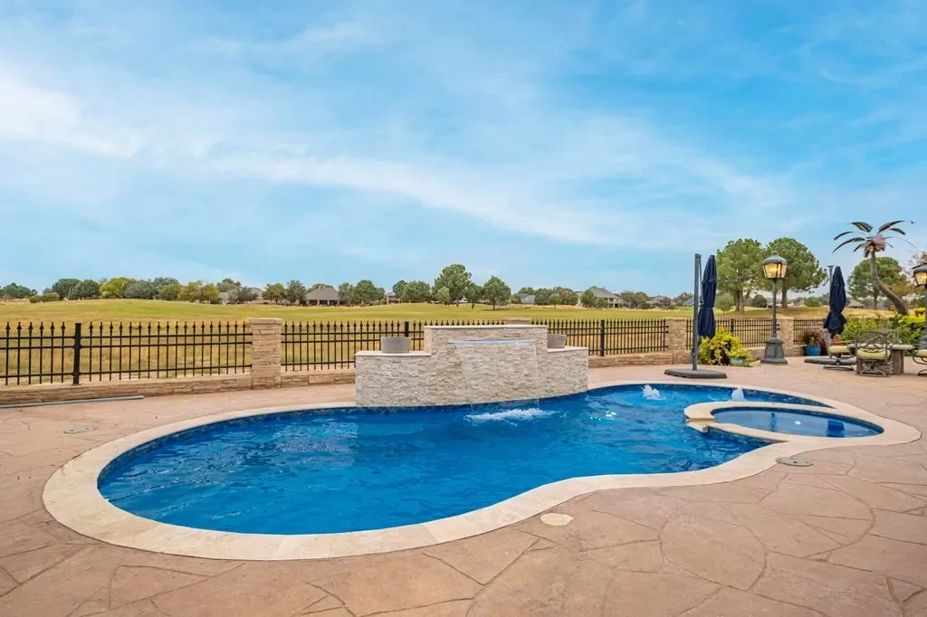 14x30 ivory coping stamped concrete and cascade.webp
