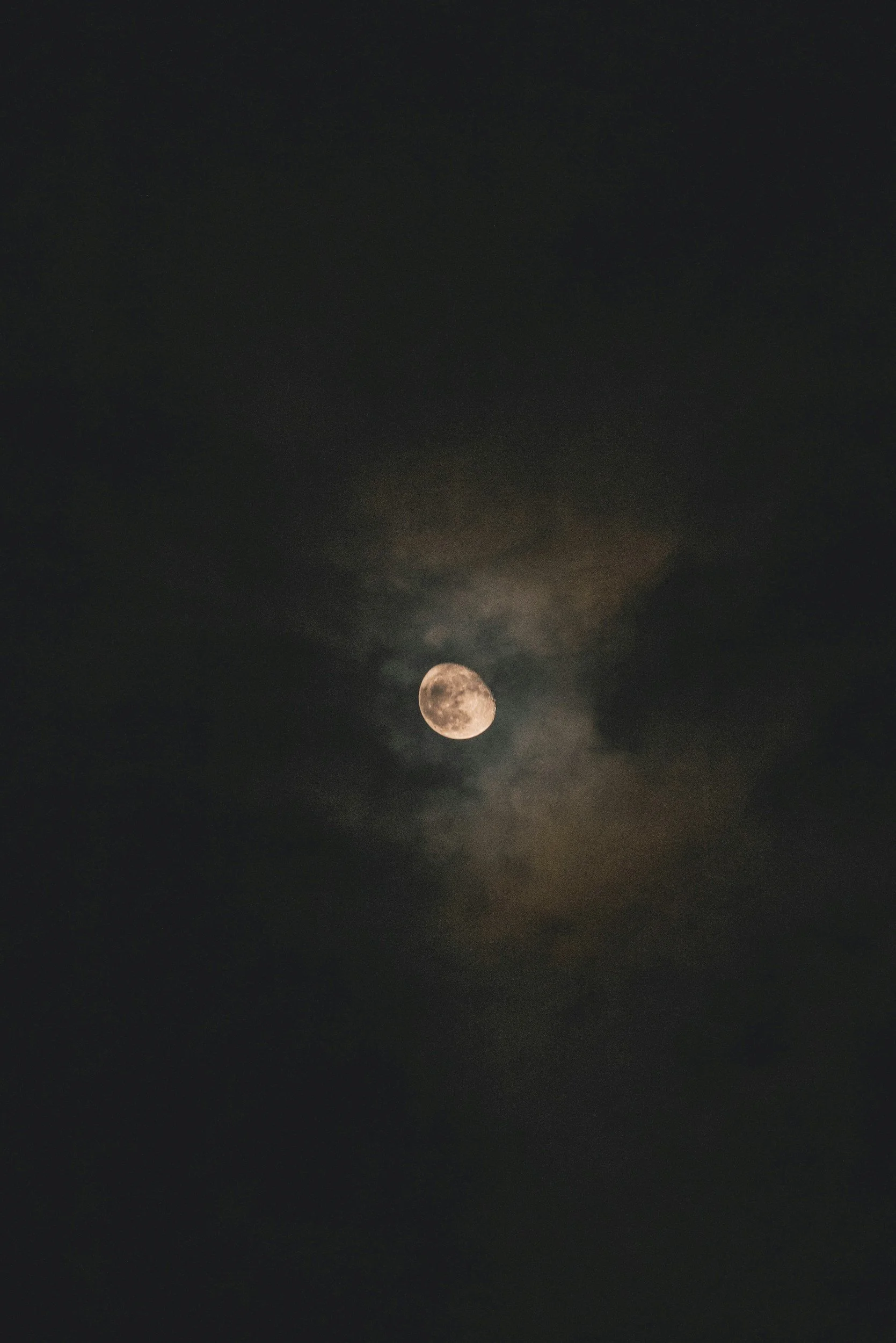 Nighttime anxiety concept with a cloudy moon in the sky, promoting virtual therapy in Jackson MI for adults struggling with sleep and anxiety at night.