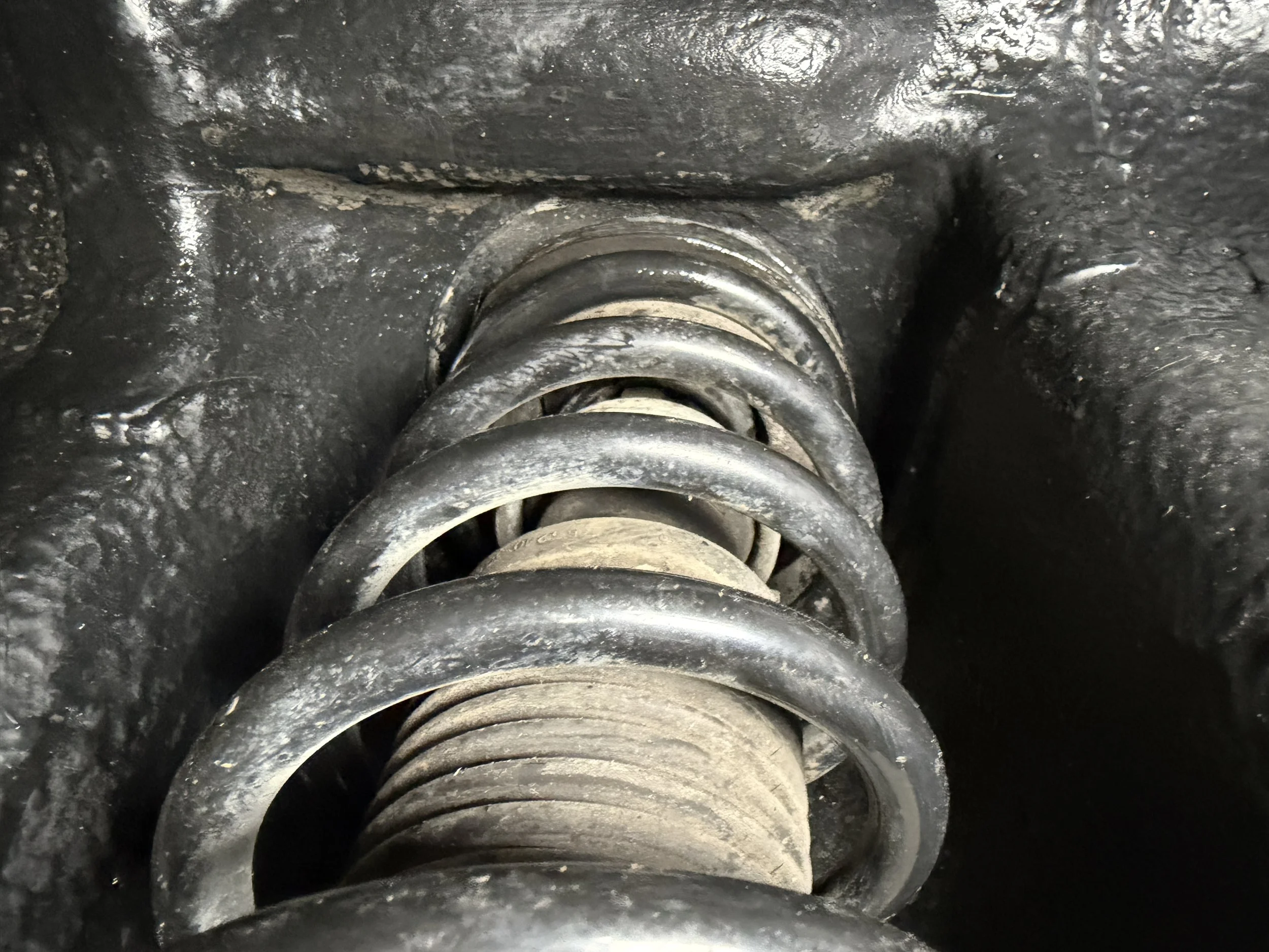 Close-up of a vehicle suspension coil spring.