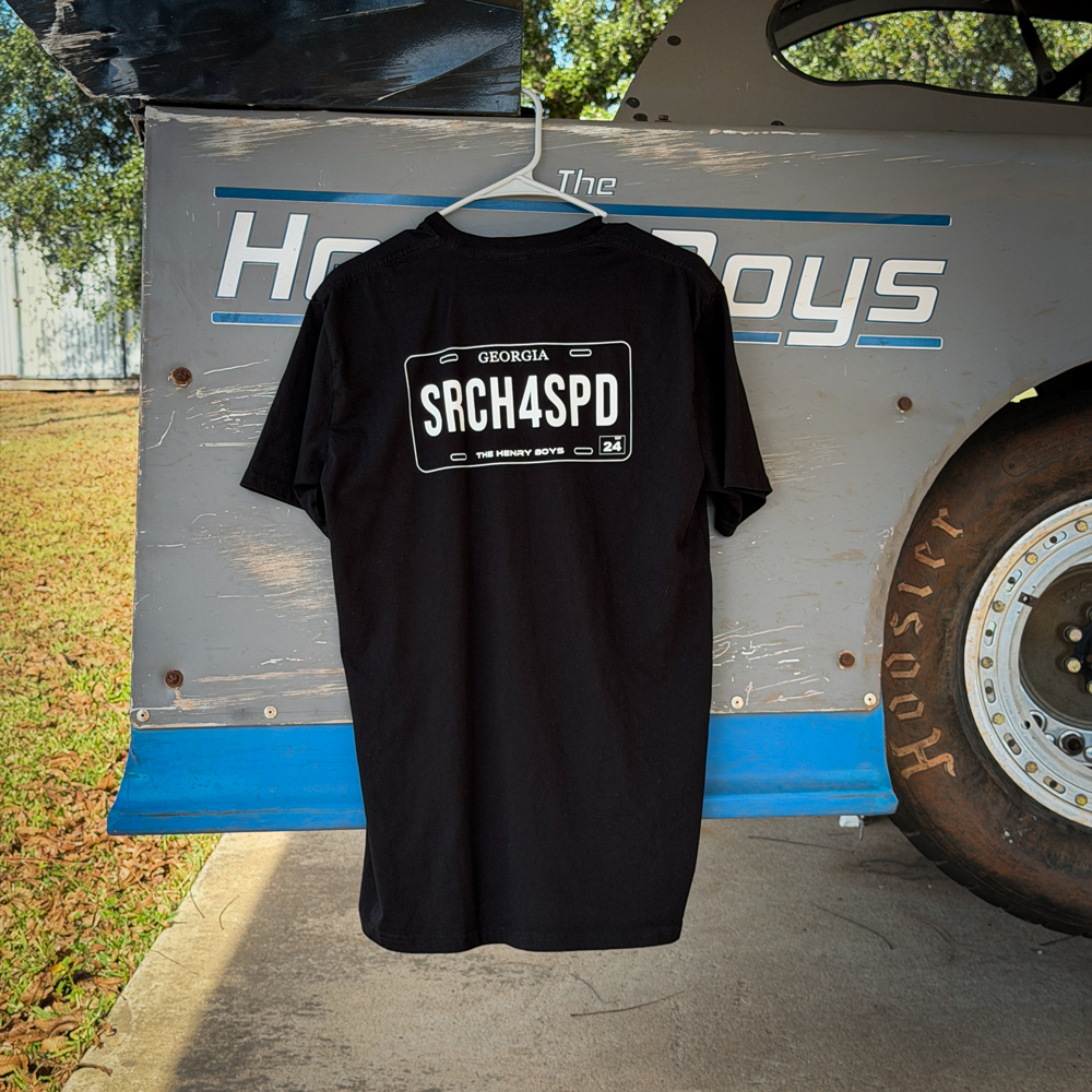 The Search For Speed License Plate shirt hanging on the side of a dirt late model