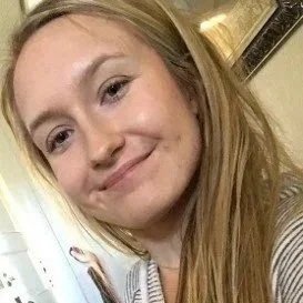 Close-up of a young woman with long blonde hair and a slight smile.
