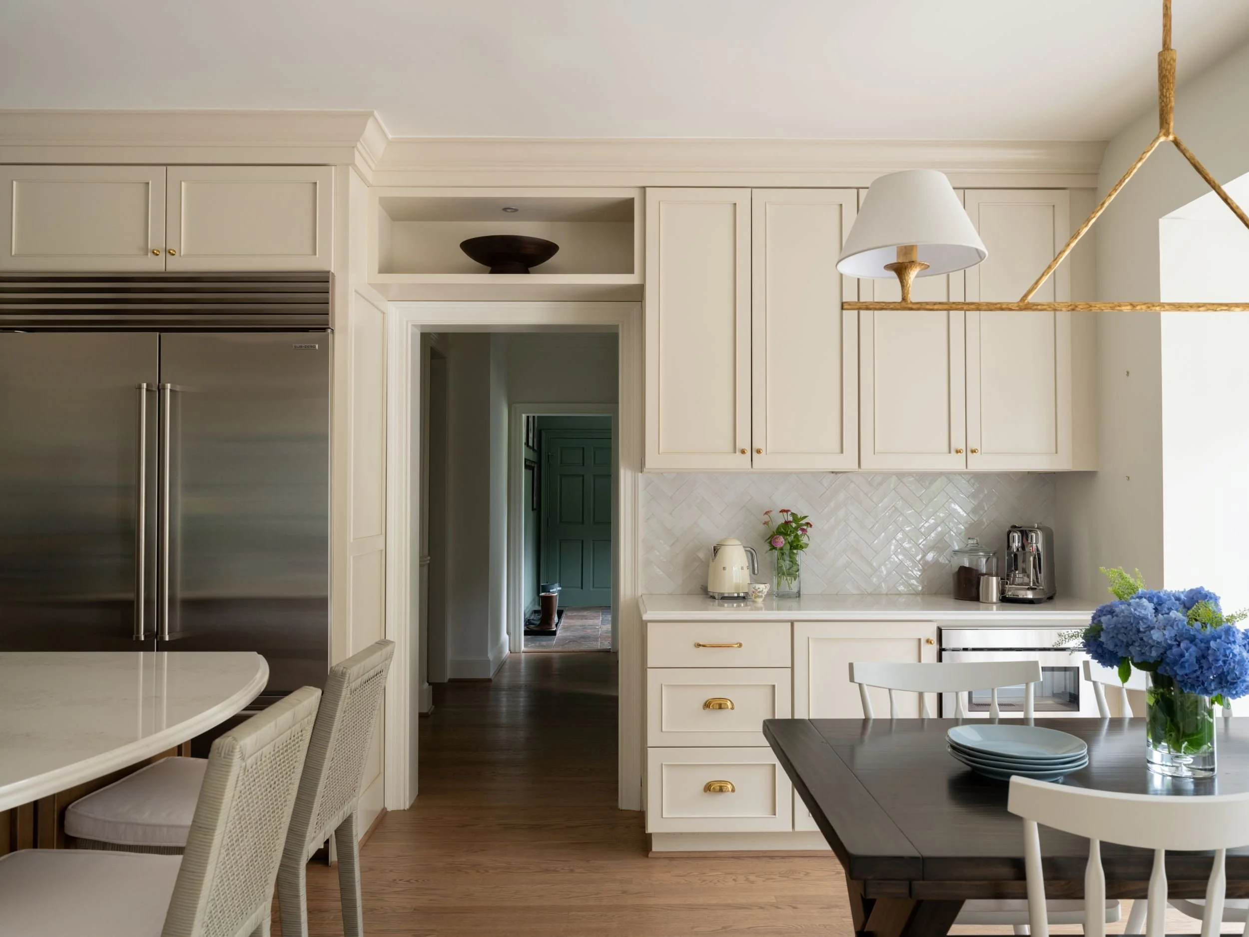 Coffee bar with cream cabinets and brass hardware. 