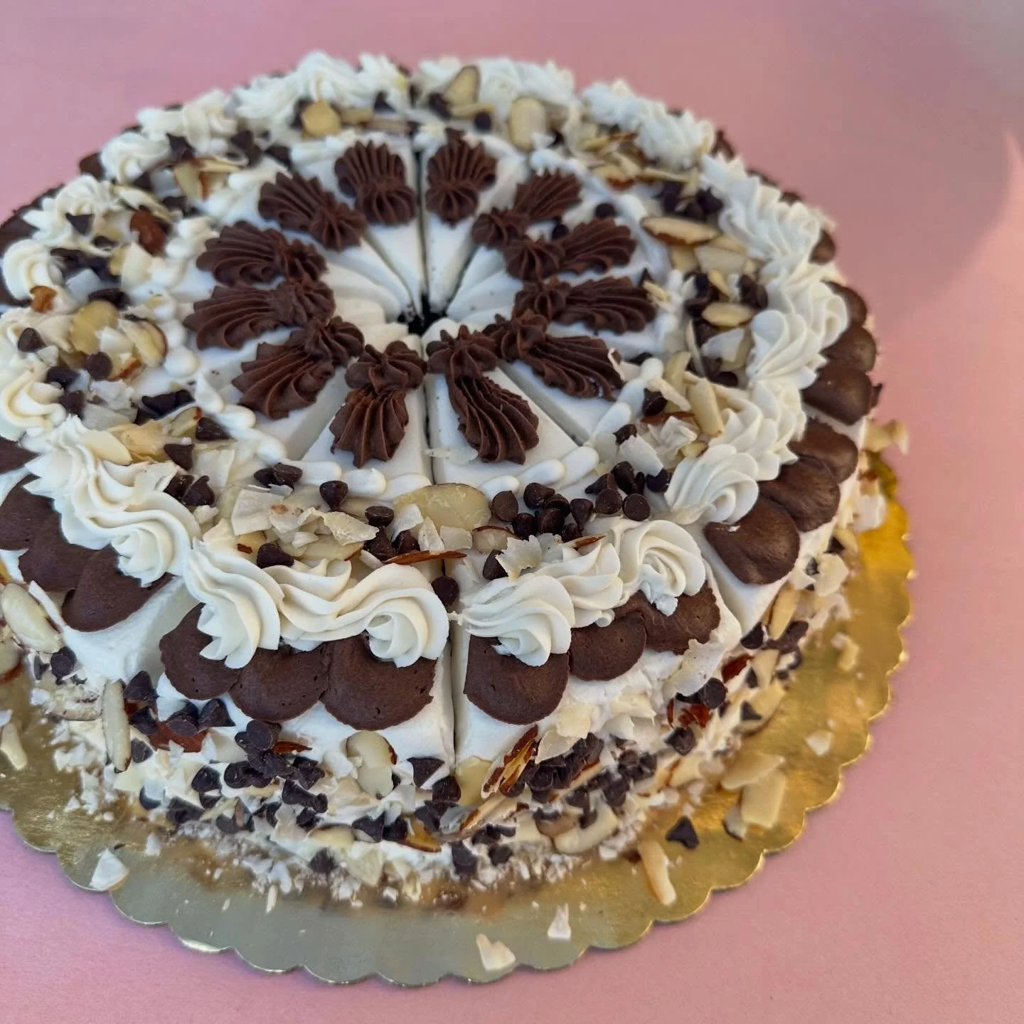 Cake by the slice this week is chocolate cake with almond buttercream between the layers, iced on the outside with coconut whipped icing topped with sliced almonds, coconut flakes and mini chips. Get yours today!