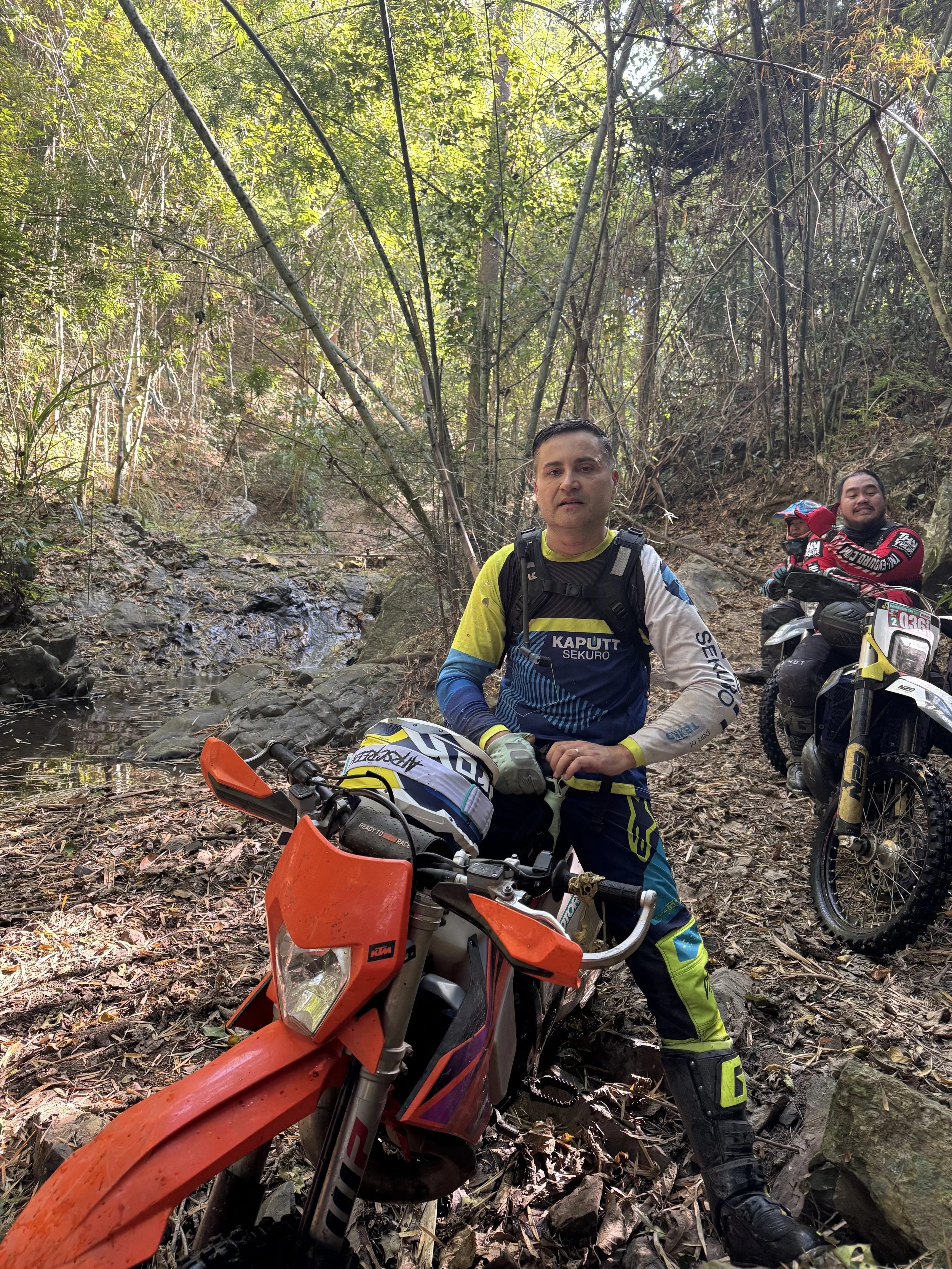 Hard enduro riders navigating rocky jungle trail in Thailand on dirt bikes – Enduro Tour Thailand adventure