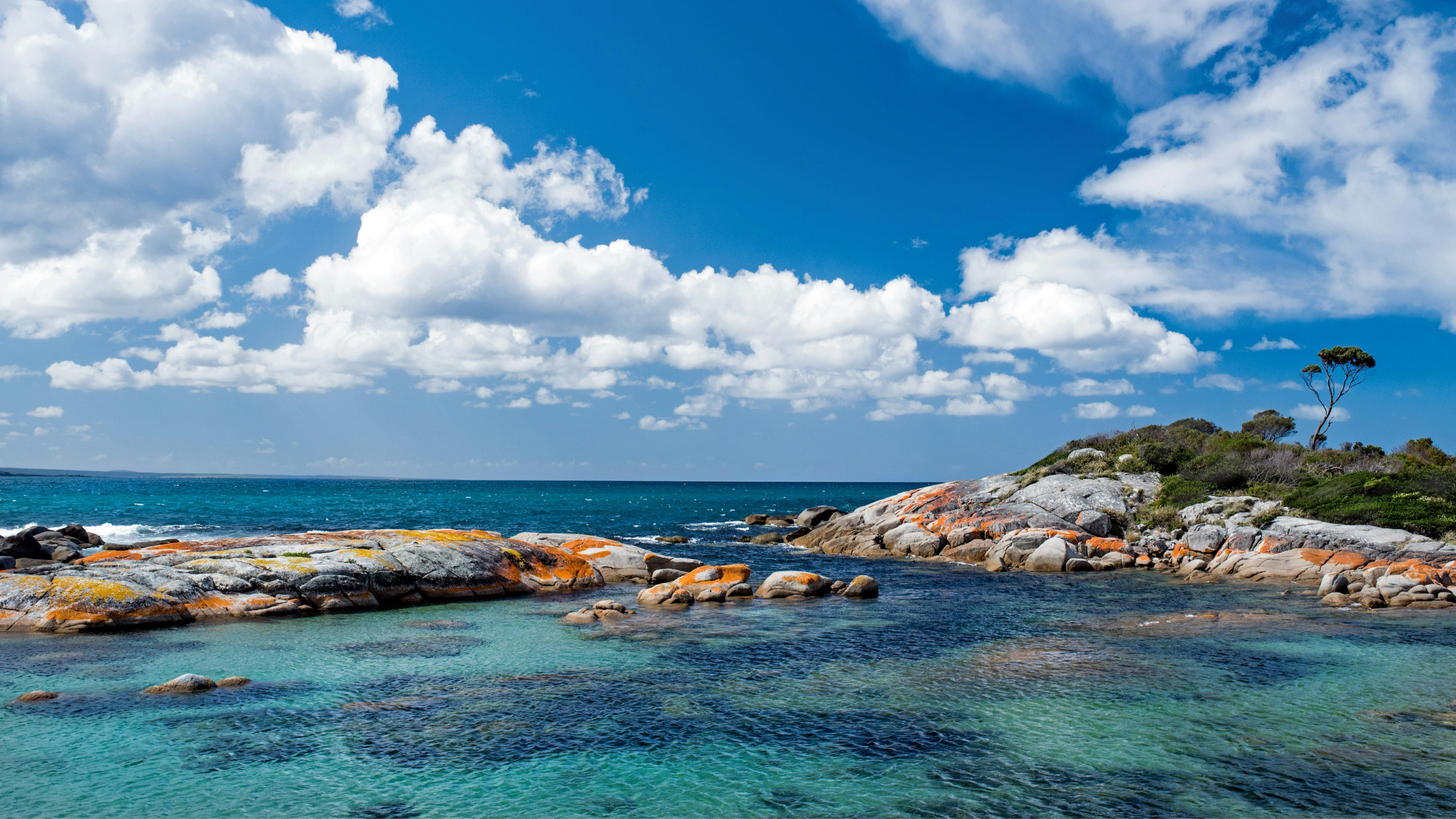 Orange rocks and turquoise water at Bay of Fires near St Helens, Tasmania.