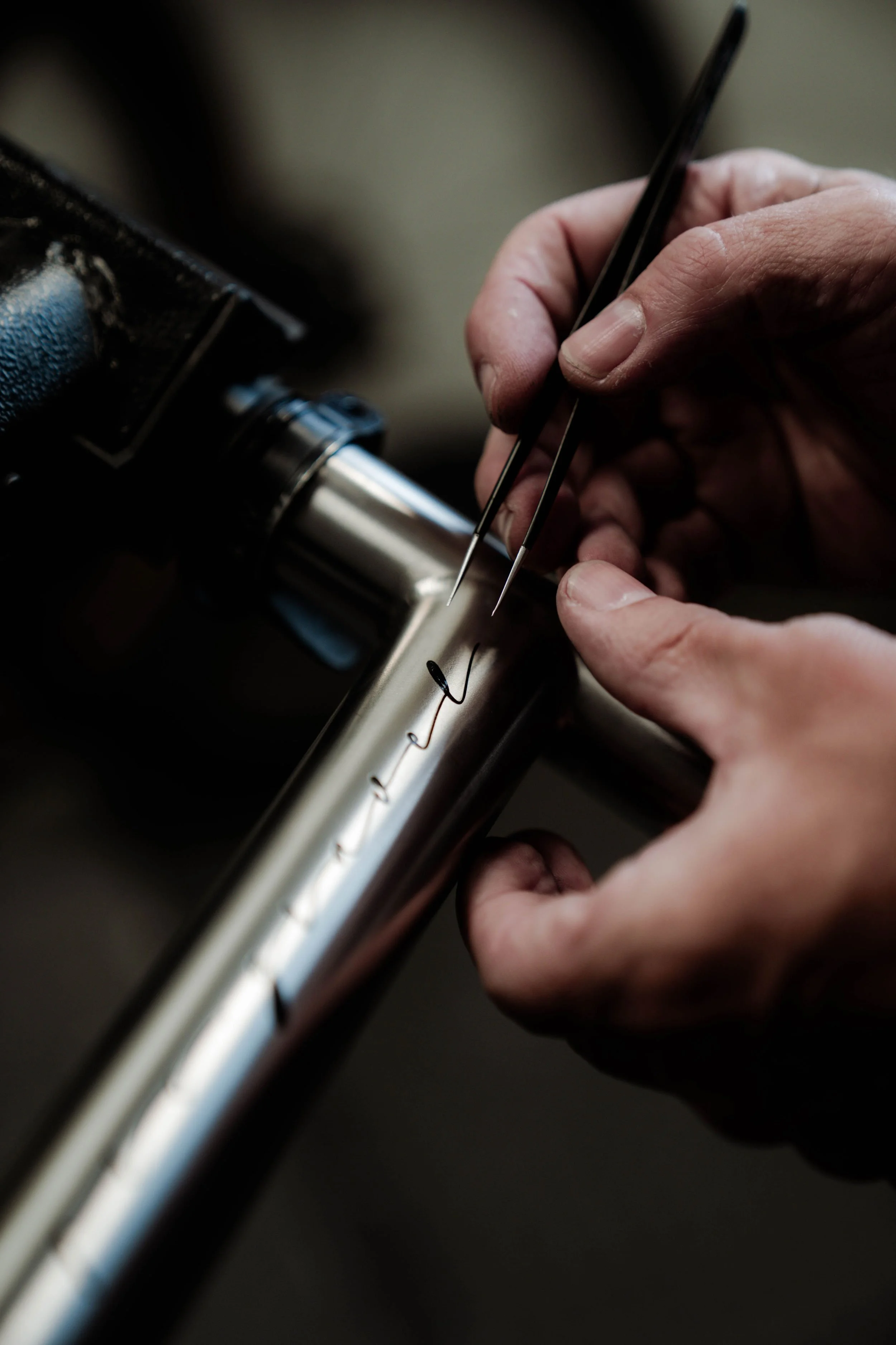 Close-up of titanium bicycle frame craftsmanship at ANGEL Cycle Works.
